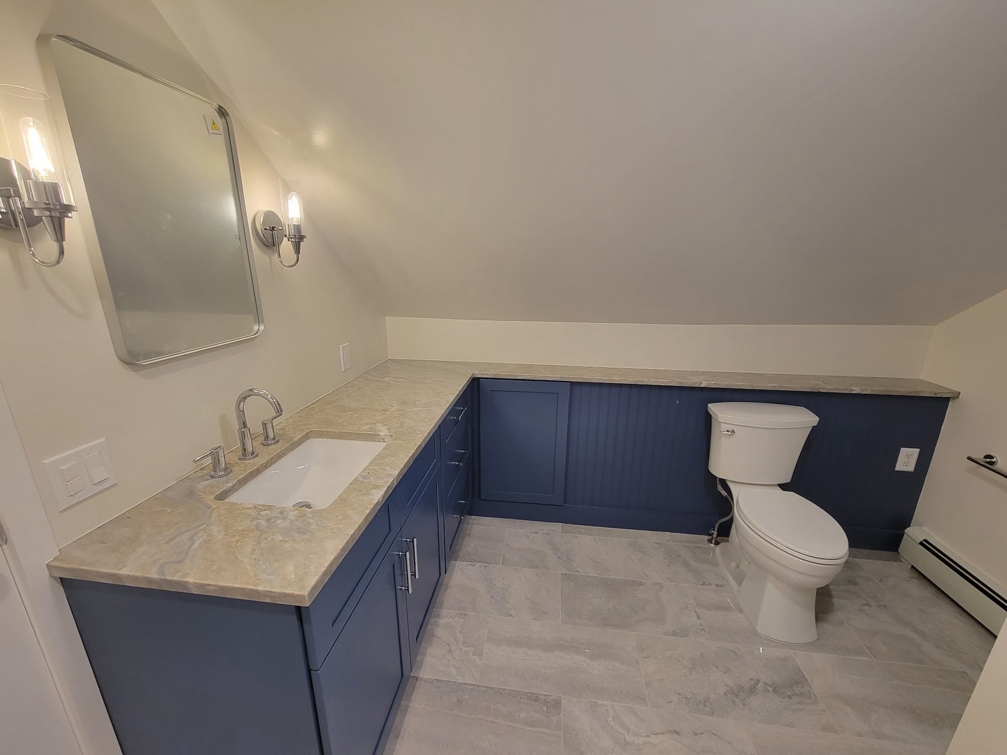 Intentionality is key in design. Swipe to the end to see what we mean 💙
What was once a very choppy, mix-matched space is now one of beauty and flow all by connecting a now larger vanity with the existing ledge (that the homeowners wanted to keep).
We did this by:
🔹Creating a door where the once voided space was which also added additional storage.
🔹Installed bead board in front of the ledge area
🔹Painted the ledge area the same color of the @fabuwood vanity
🔹Installed quartzite counters from @jfgraniteandmarble over the entire area
All matched with beautiful floor and shower tile from @thetileshop and chrome fixtures, and this bathroom now has comfortable cottage charm
Designed by @jonnaannesolimine
Built by @soliminecontractingllc