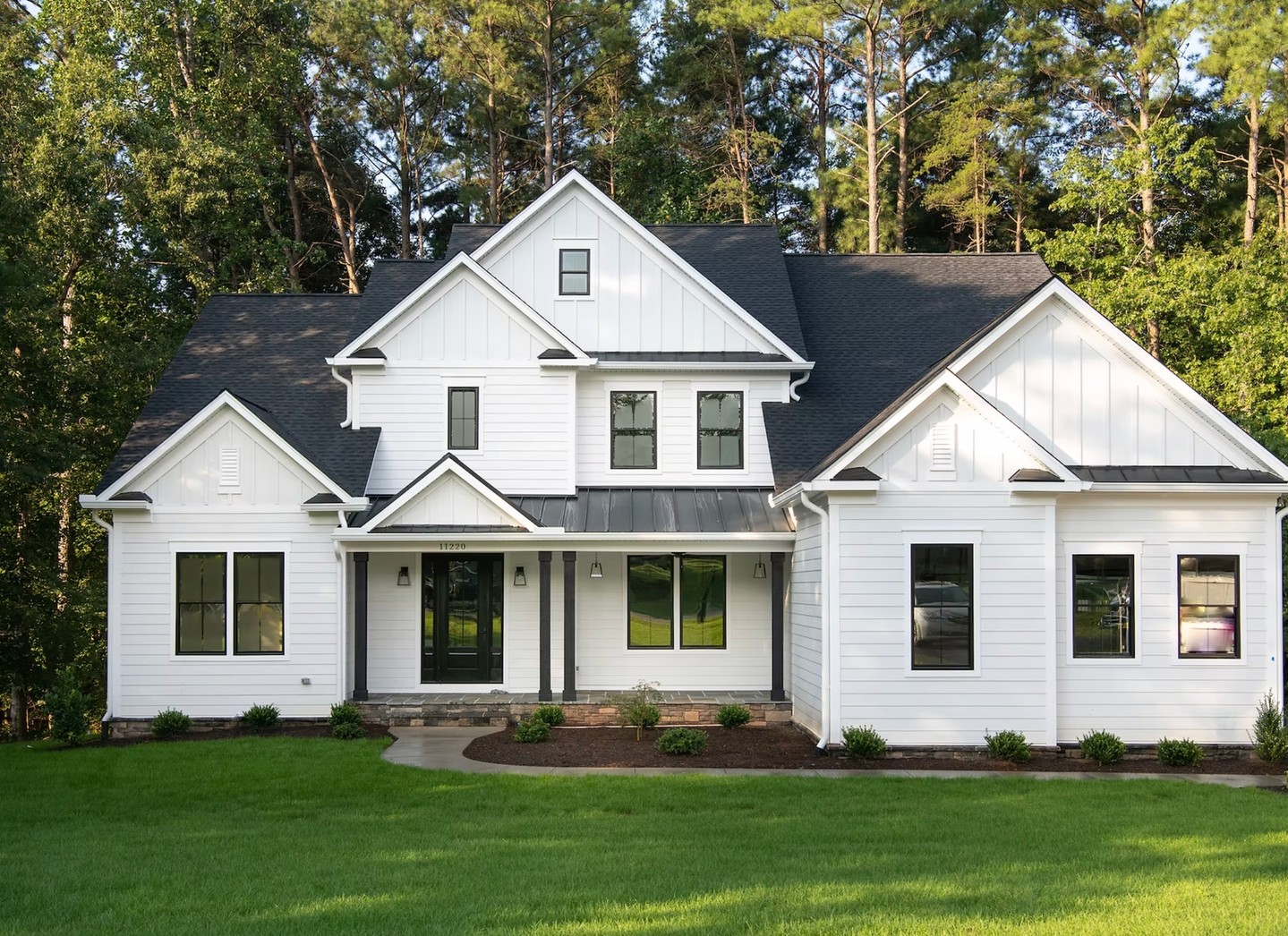 Ready for your dream home by summer? This stunner in Spotsylvania County arrives Summer 2026. Crisp white farmhouse exterior, black windows, perfect curb appeal amid lush trees. Move-in ready beauty awaits!