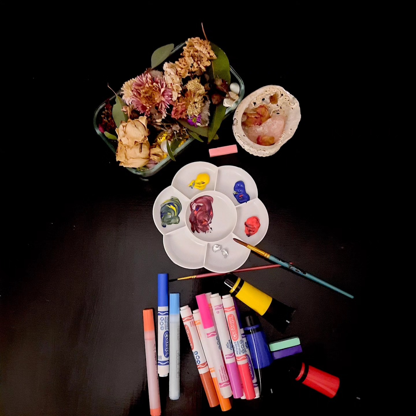 The photograph above captures a serene still life from the art therapy table after our inaugural workshop, aptly titled Symphony of Self at @greenmondaystudios with musician @ohhmusic_ The workshop was a sold-out event, offering a nurturing experience with activities like guided meditation, nature mandala creation, an art session, and reflections. Participants found the art-making and reflective writing most enjoyable, feeling calmer and inspired. Positive feedback highlighted the gentle guidance and relaxing atmosphere. A meditation script with Ohh's soothing sounds which aligns with the workshop's theme will be available for download to our newsletter followers soon .. so be sure to be signed up. Link in bio.
ID: birds eye view of black table with art materials and dried flowers on.
#arttherapist #arttherapy #artpsychotherapy