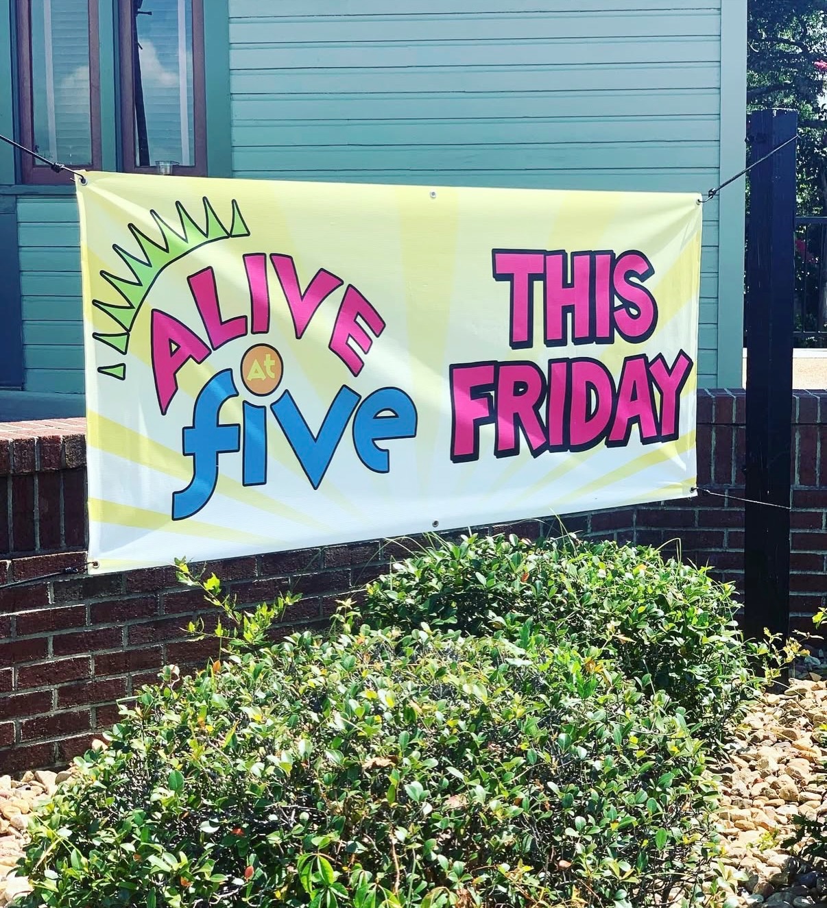 “Back in the day when I had a 9-5 job, I always loved Friday afternoons, finding bands, having a beer, hanging with friends, getting a bite to eat. So, we thought, why not bring that to Downtown MHC. Let’s get people to Downtown.”
- Keri McCann, owner of Jack’s
Alive at five started as a simple idea to bring people together downtown. Keri rallied volunteers, DMCRA’s board, Tom Kies (Director of DMCRA), her husband, Jeff and the city to make this event happen.
The first stage was nothing more than a semi-truck trailer bed. (Tom Kies remembers it being “dusty and dirty.”) Katherine Davis Park was chosen as the location, with permission from the railroad, which owned the property and leased it to the City for parking. The City provided bleachers, Keri had shirts made for the volunteers, and Alive at Five was born.
At the time, selling beer and wine on municipal property was unheard of. Still, the City Council approved it. “Everybody was working together back then. Everybody wanted everything to succeed”, recalls Tom Kies. Resolutions were approved and ABC permits were issued.
Alive at 5 started as a free monthly summer concert series, with bands paid through sponsors and partners. Some of the very first sponsors were R.A. Jeffreys Distributing Company, Sammy’s Ice House, Dee Gee’s, and Twice the Ice. Needless to say, it didn’t take long for the series to grow.
Keri said, “It wasn’t a huge money maker, but it did what it was supposed to do. Bring family and friends together to enjoy a band on a Friday (or sometimes Thursday) to our growing downtown area. The businesses worked so well together to create a “new” area for groups of people to come and enjoy. And, with a water view.”
Today’s Alive at Five consists of staging, tents, vendors, and related expenses. But, the original idea remains. This free family-friendly event is meant to bring community together. It strengthens camaraderie through shared moments, conversation, and local pride, while also providing numerous opportunities for shopping, dining, and other activities for attendees in our downtown. DMC, Inc. is honored to continue this yearly tradition.