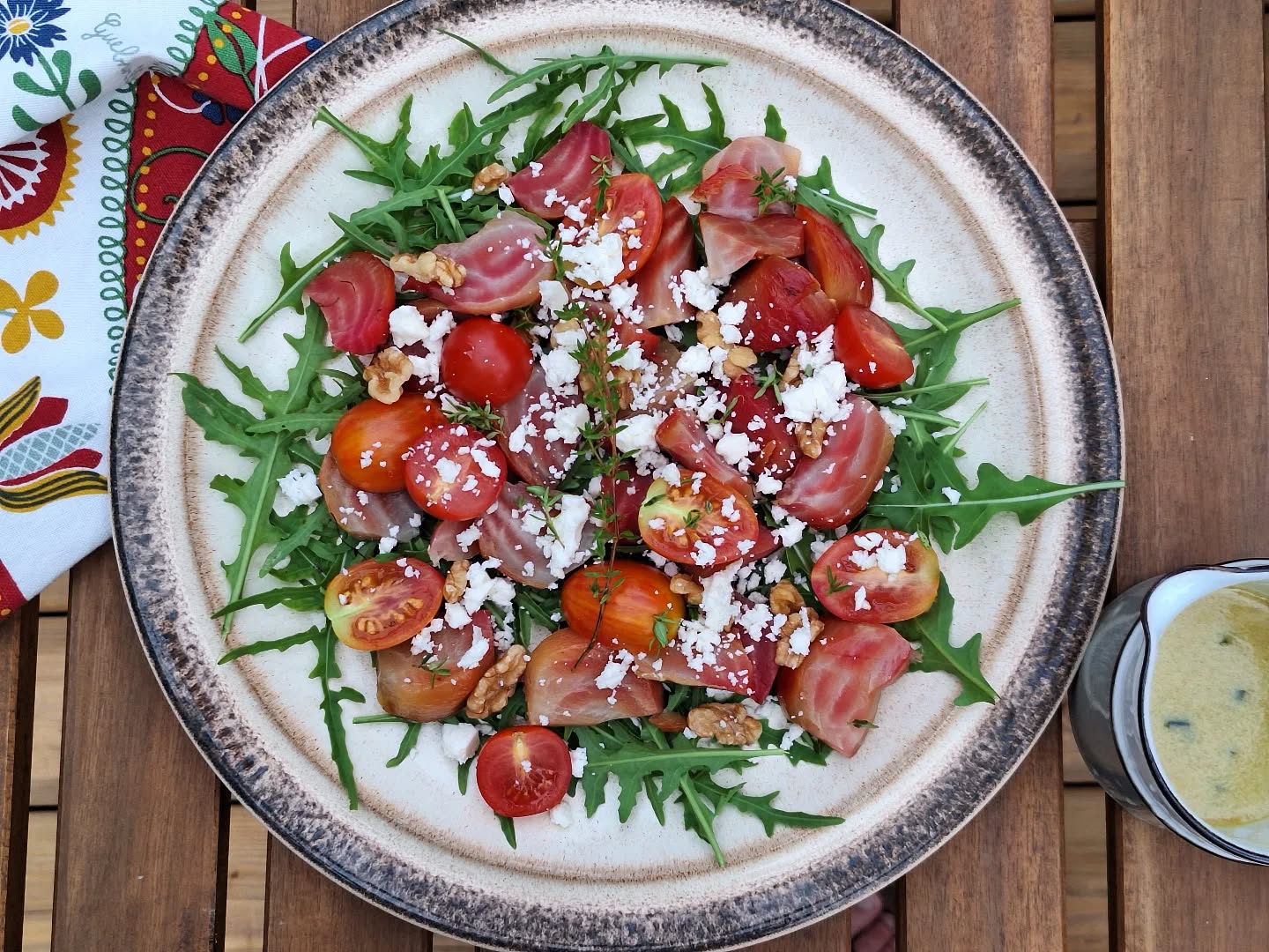 Easy summer meals: candy cane beet salad with walnuts, and arugula and tomatoes from the garden. Topped with feta and served with a Dijon, thyme, and white wine vinaigrette.