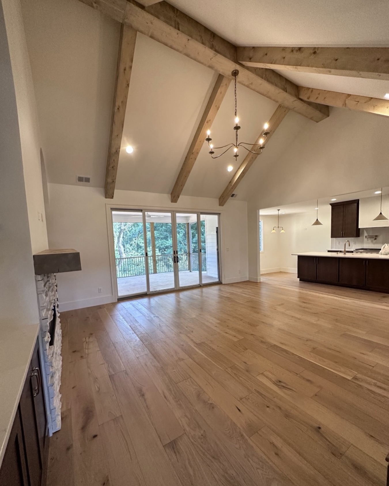 Vaulted ceilings, exposed beams, and wide-plank hardwoods set the tone in this open-concept living space. 🤎
Natural light pours in through oversized sliding doors, leading to a covered deck surrounded by trees—perfect for everyday living and effortless entertaining.
#vaultedceiling
#exposedbeams
#customhomebuilder
#jontotherowconstruction