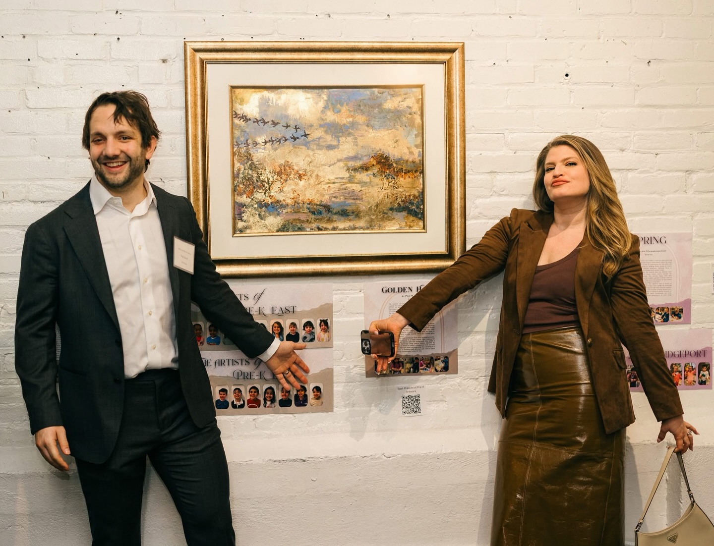 Congratulations to the Jacob Family ❤️ #POTAArtAuction
Prek East: Golden Flock
The creation of Golden Flock was a collaborative journey inspired by autumn colors, bird migration, and the gold leaf ground on which the painting was created. The artwork represents the children’s two-week learning journey, culminating in a richer understanding and appreciation of art and nature.
The children began by exploring the fall theme through photos of themselves jumping in vibrant, colored leaves on the playground. They examined fall landscape paintings and learned to paint on gold leaf using brushes and sponges, creating smaller, individual canvases as they practiced working with the delicate materials.
Next, the children learned about bird migration through stories and images of birds flying in V formations, sparking conversations about flying in flocks and animal behavior during different seasons. As they created birds on their own mini canvases, some remarks included, “Look, my birds are flying in all directions!” while another shared, “Mine are Canada geese flying south together!”
Finally, using the same techniques from their personal artworks, the children transitioned to a larger canvas. After helping the Morah apply the delicate gold leaf background, they added a subtle autumn landscape using palette knives, followed by sponges dipped in water to create a transparent wash and add texture. Each child then drew one migrating bird, resulting in a whole flock in a V formation and allowing each child to leave their signature in a meaningful, collective way.