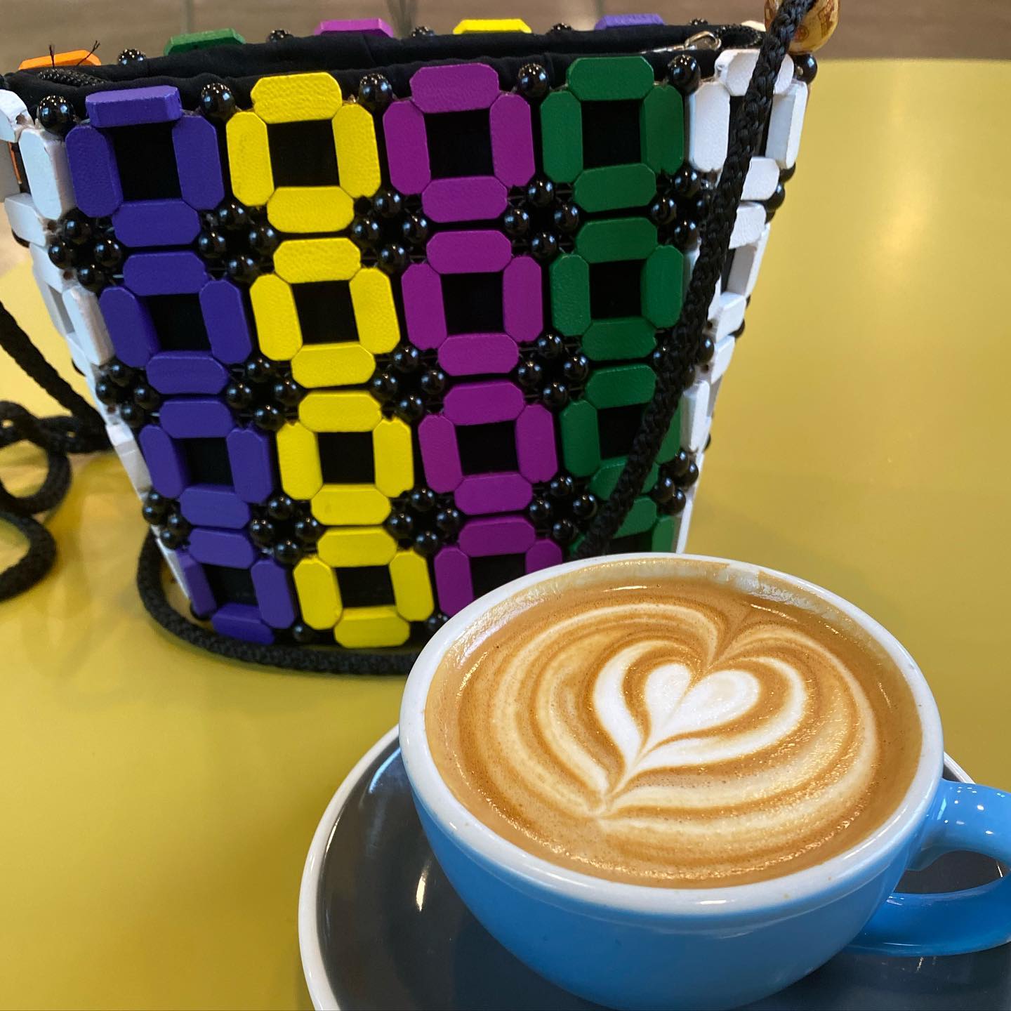Cure those midweek blues with a latte from @scout.vt & one of our colorful wood beaded bag 🎉
.
.
.
.
.
.
#midweek #coffee #latte #bag #wood #beaded #handmade #ghana #internationalartist #globalcommunity #accessories #colorful #creative #shoplocal #shopsmall