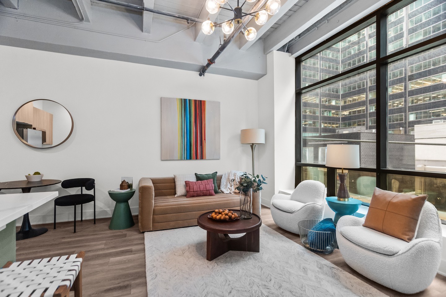 Rounded silhouettes, luxe materials, and pops of color bring this loft space to life! #loft #luxe #chicago #chicagorealestate #havenhomestager #chicagohomestaging #stagingworks #stagingsells #staging #homestaging