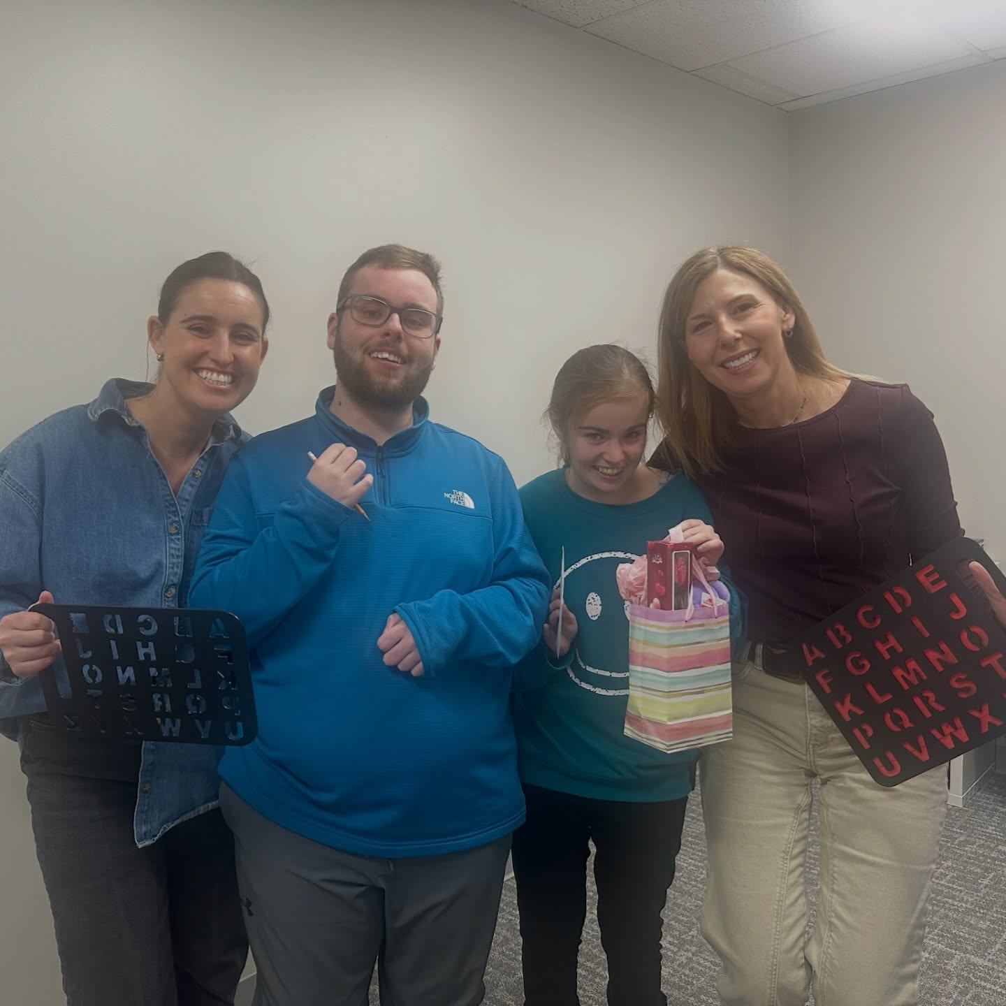 Tomorrow is Valentine’s Day.
For some people, that means flowers or dinner reservations. For others, it means something even more fundamental.
When you have reliable access to communication, you have access to connection. You can ask someone out. You can say yes. You can say no. You can figure out what you feel and whether the other person feels it too.
That is not something everyone has been given.
The young adults in our community deserve the same awkward, exciting, ordinary experiences as anyone else. Friendship. Attraction. Boundaries. Belonging. The chance to choose.
Relationships are not a luxury. They are part of being human.
Communication access is what makes that possible.
Access to communication is access to possibility.
Image ID: Four young adults stand close together in a classroom space, smiling at the camera. Two are holding alphabet letterboards. One person in the center holds a small gift bag with tissue paper and a card inside. The group appears relaxed and happy, suggesting connection and celebration.
#CommunicationIsAHumanRight
#PresumeCompetence
#AccessToConnection