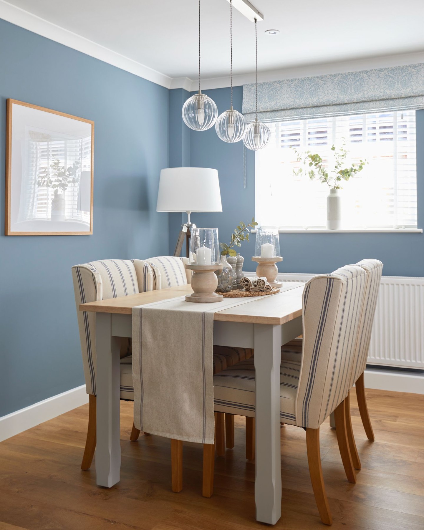 ~ A calm, coastal-inspired dining space designed for everyday living.
~ Soft blue walls create a relaxed backdrop, warmed up with oak flooring and an oak-topped dining table to keep the space feeling grounded rather than cold.
~ Simple glass globe pendants give light without visual clutter, while striped dining chairs and a fabric runner add pattern and texture in a subtle, unfussy way.
~ Finished with layered artwork, greenery and a Roman blind in a classic Morris fabric to bring softness and character into the room.
#interiordesignuk #diningroomdesign #calminteriors #timelessinteriors #realhomes
interior designer near me | interior designer uk | residential interior designer | home interior designer | dining room interior design | interior designer hampshire | interior designer surrey | interior designer berkshire | interior designer west sussex | interior designer wiltshire | calm interior design | coastal interior style | timeless interior designer | interior designer for family homes | room makeover interior designer | interior design consultation uk | online interior designer uk | interior designer for real homes | modern country interior design | traditional interior designer uk | Amy Elizabeth Interiors