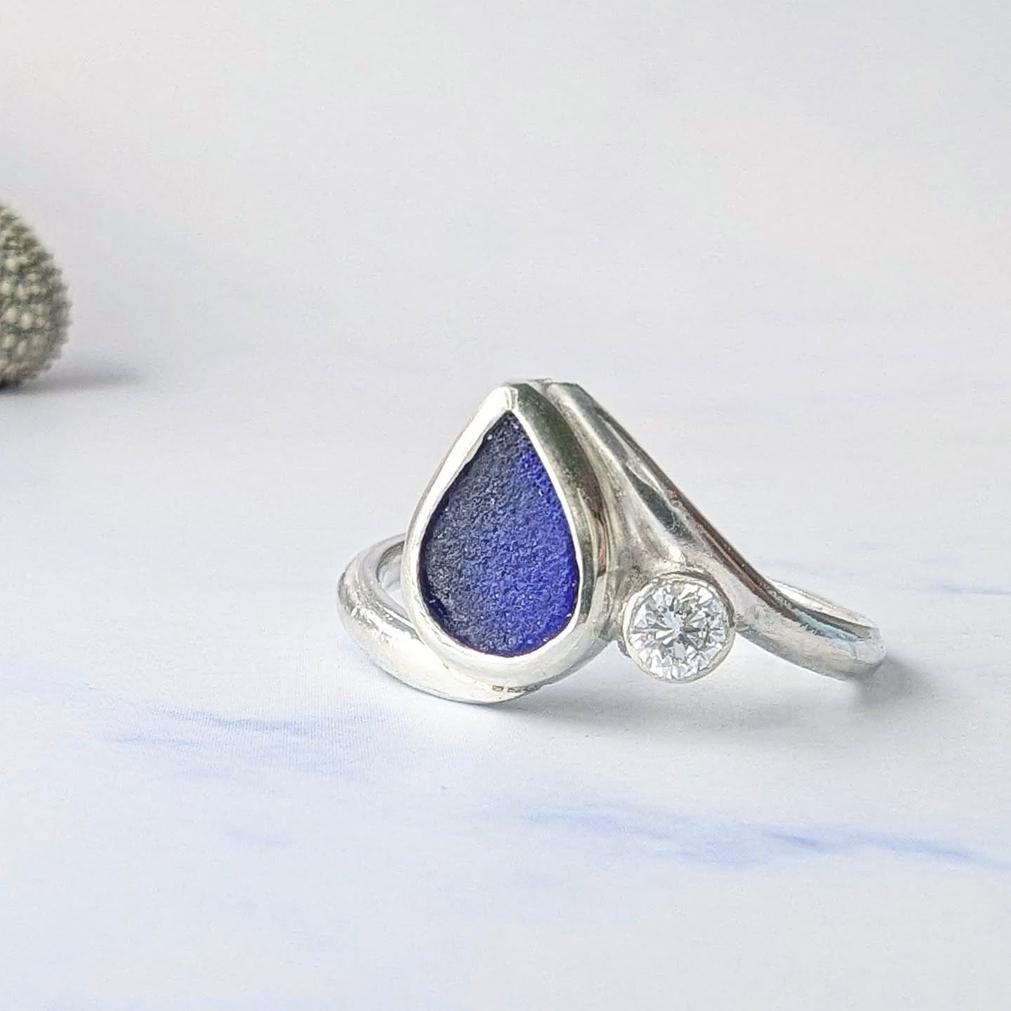 Beautiful beautiful cobalt blue sea glass engagement ring. The Luna is a stunning ring designed to capture the moon and the stars and the sea.
Luna is named after the ancient Roman Goddess, honored on the new and full moons, and sometimes associated with fertility and childbirth. Luna was considered a "two-horned queen of the stars". Her name, Luna, was derived from the Latin "lucere" which means to shine. This ring hopes to capture the brightness of the moon, in the diamond. The darkness of the night sky, in the deep blue sea glass and the curve of the waves in the sweeping band.
All rings are individually custom made to order, visit the website for more details.
#seaglassjewellery
#seaglass #seaglassengagementring #ethicallymadejewellery #alternativeengagementring