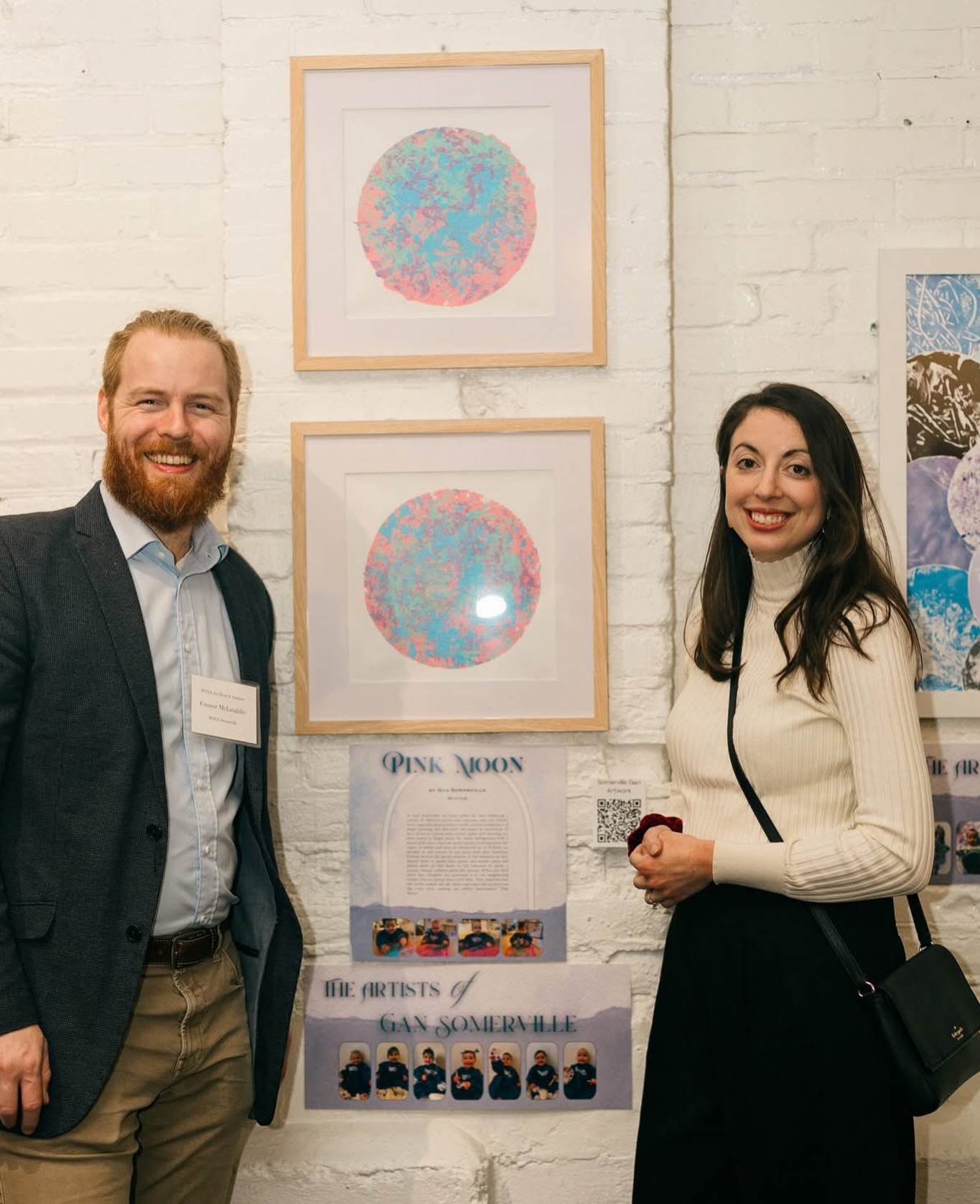 Congratulations to the McLaughlin Family ❤️#POTAArtAuction Somerville Gan: Pink Moon
In Gan Somerville, we have spent the year exploring a variety of different paints and canvases, and our friends have especially shown interest in the sensory experience of finger painting. For this piece, we began by sectioning off two circles on canvas with contact paper and allowing our little artists to finger paint the entire background with a pastel pink color. Since we spent January learning about the topics of winter and trees in connection to Tu B’Shvat, we decided to add texture to our piece with pine branches. Friends noticed the prickly texture of the branches as they dipped them in pastel blue, green, and purple paint and patted them up and down on the canvases to create a unique, bumpy, splatter paint-like texture. When our final piece was complete, we presented it to our neighboring toddler friends during their circle time. They observed that the circles looked like the moon and especially pointed out the color pink, naming our wintry masterpiece “Pink Moon.”