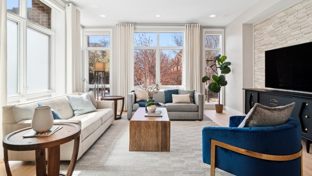 We carved out a spacious living area in this open floor plan home to show flowing conversational and lounge opportunities. And we used greenery and pops of blue for subtle doses of color. #luxe #chicago #chicagorealestate #havenhomestager #chicagohomestaging #stagingworks #stagingsells #staging #homestaging