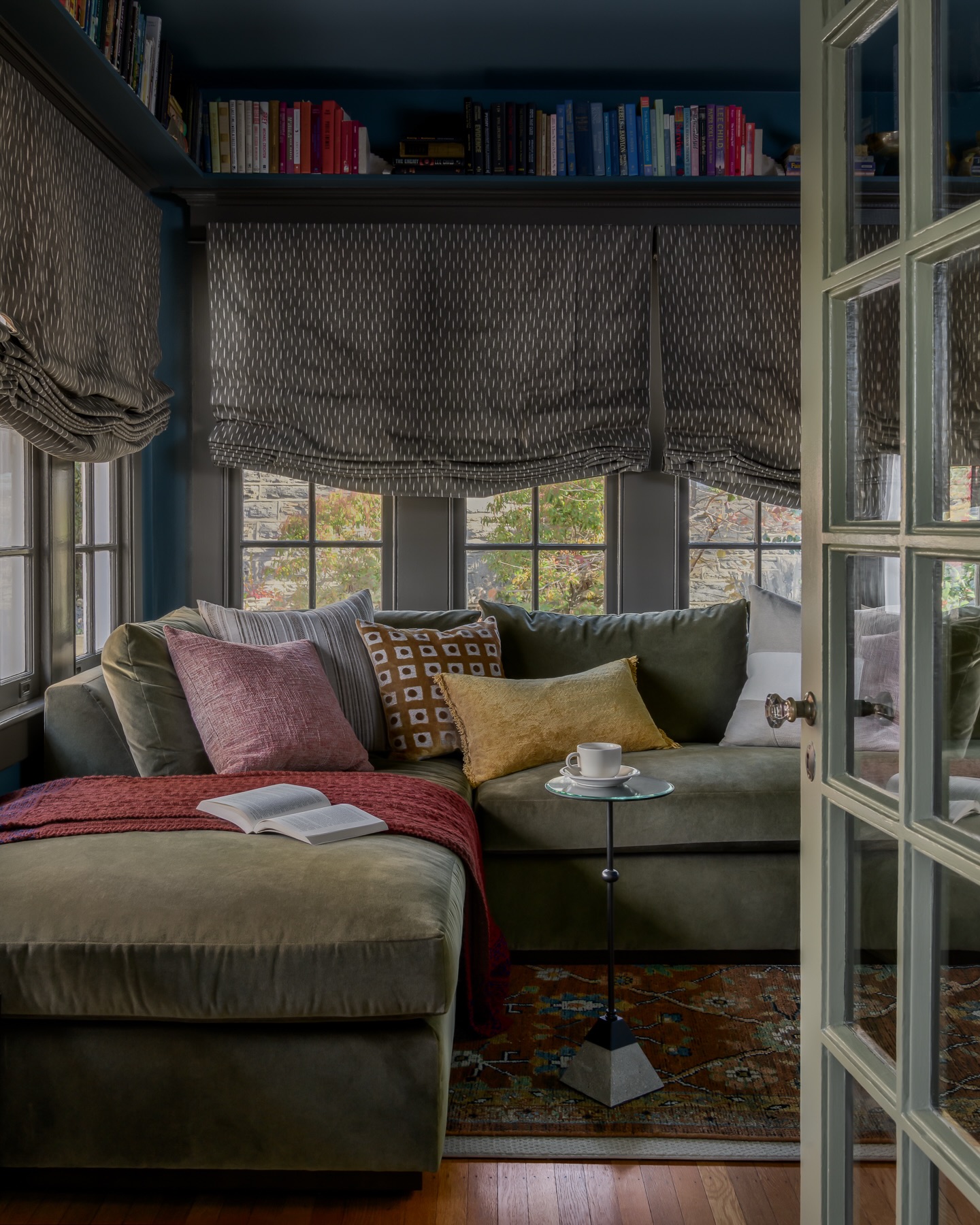 Who doesn’t love a moody sunroom transformation?
Now filled with music, games, and plenty of spots to get lost in a good book, this den does it all.
It’s laid back, lived-in, and dare I say the favorite room in the house.