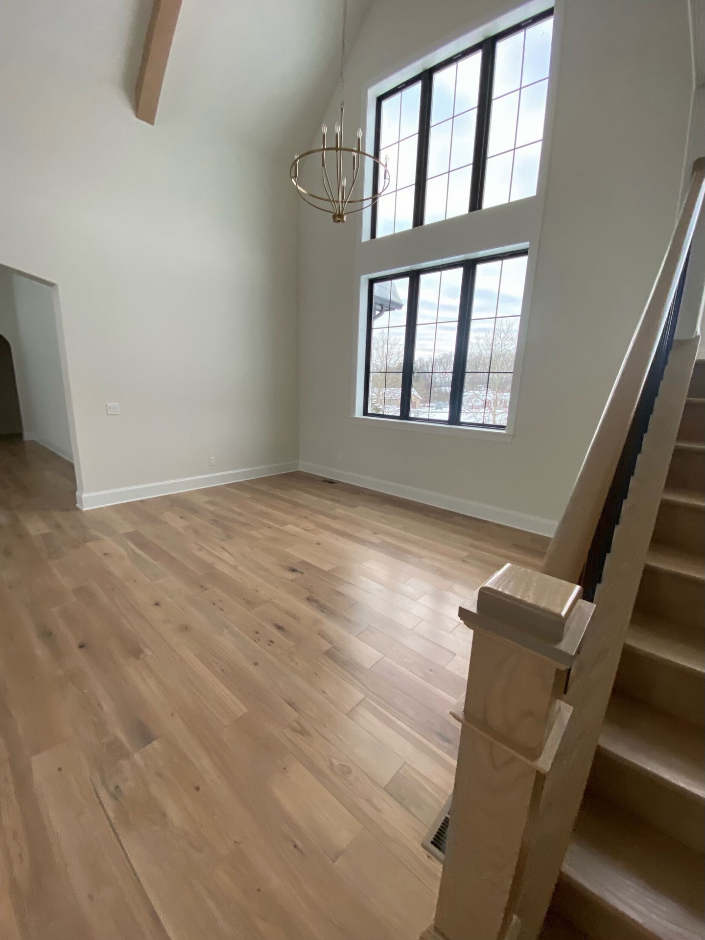 This stunning 6” white oak, character grade, plain sawn floor in Antique White finish brings warmth, texture, and quiet luxury to this home. #OldWorldCustomHomes #TimelessDesign #GrafCustomHardwood #CharacterGrade #PlainSawn