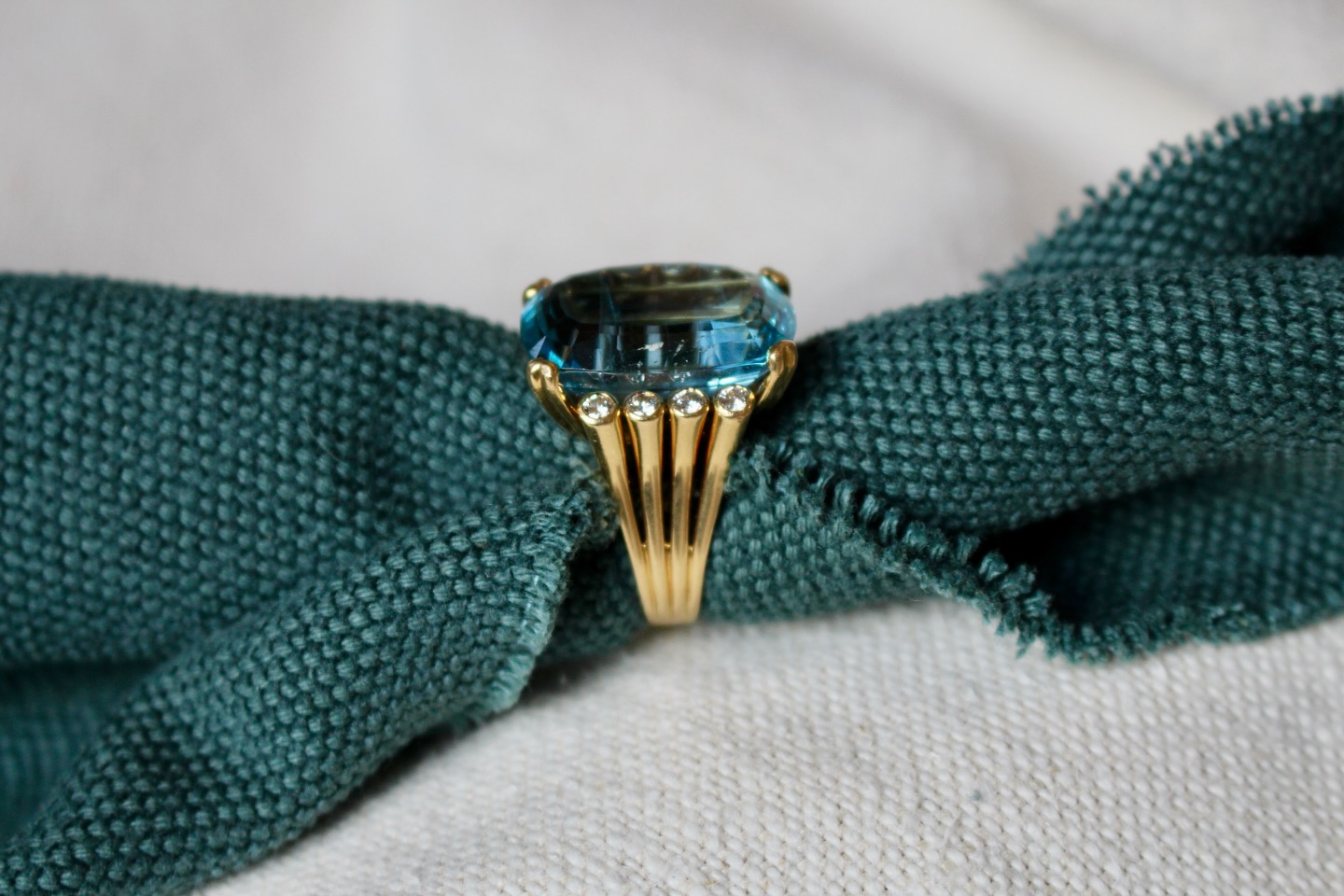 Taking a closer look at this fabulous large aquamarine statement ring
This stylish ring is set with an oval cut aquamarine of over 25.00 carats, mounted in a 4 double claw mount with wide fluted shoulders and diamond set terminals. The aquamarine is a wonderful, vibrant blue in colour, which is beautifully set off by the rich yellow gold setting.
The ring dates from the late 1970’s and is typical of the bold but easy-to-wear cocktail rings of the period.
#aquamarine #cocktailring #statementjewelry #ringoftheday #vintagejewellery