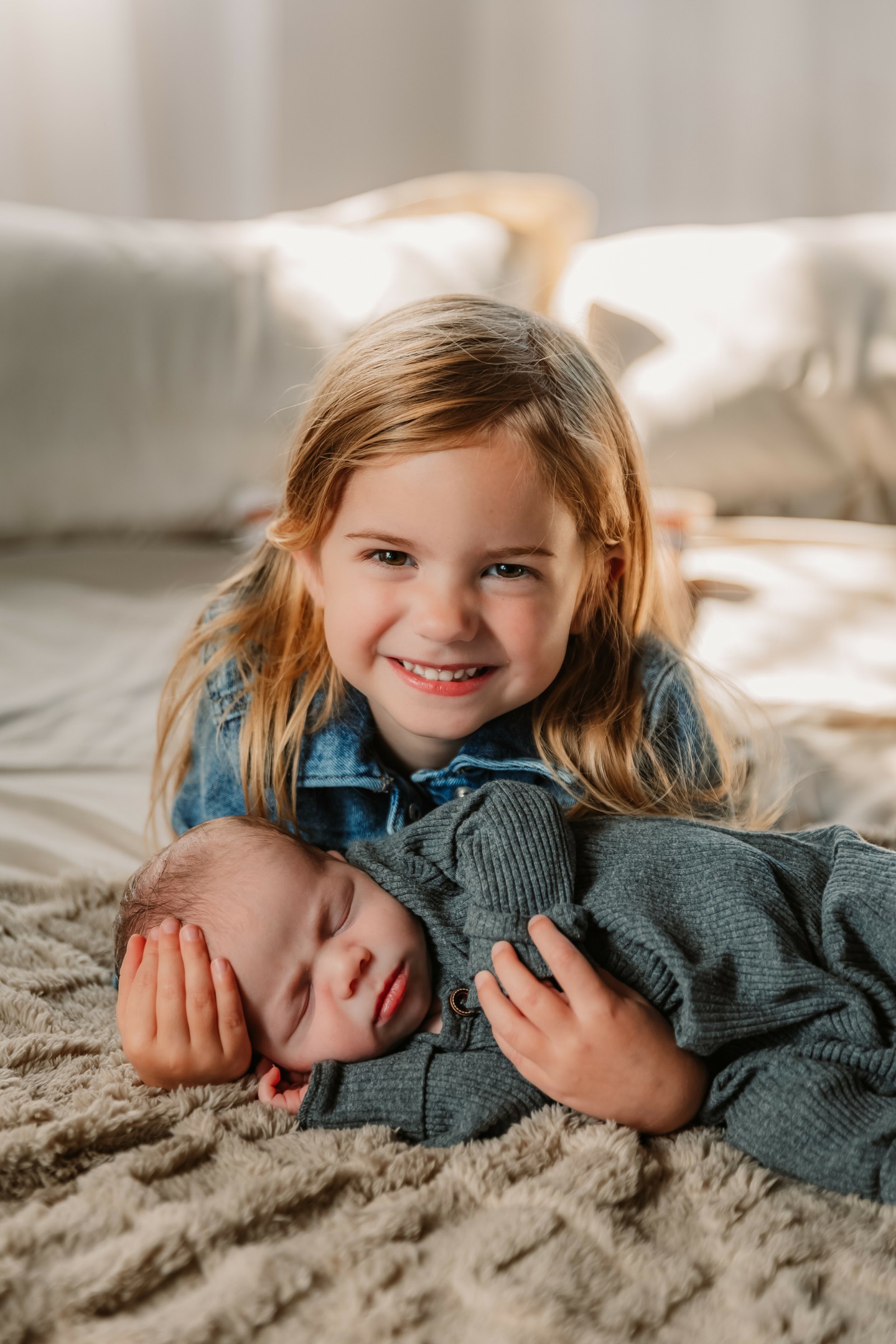 These days are fleeting.
The tiny fingers. The sleepy stretches. The way they fit perfectly in your arms or their sibling's arms.
Newborn photos freeze a chapter you’ll never get back — and you’ll be so grateful you did this.