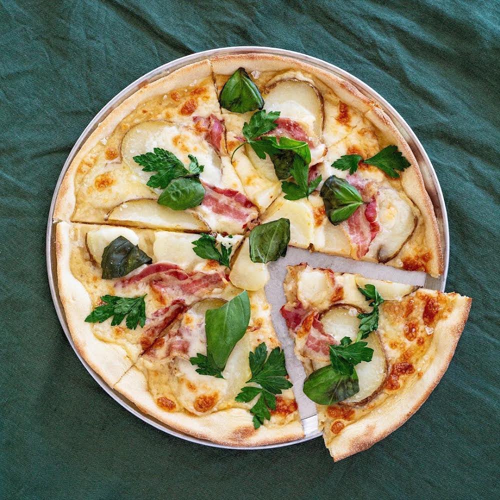 Salt baked Dorrigo potatoes, creamed leeks, gooey taleggio, smoked mozzarella and pancetta.
When it works, it works 🤤
An instant icon, here to slay
The Famous Dorrigo Potato has made the cut in our core pizza menu.
Whats your favourite? Let us know your fav pizza in the comments below