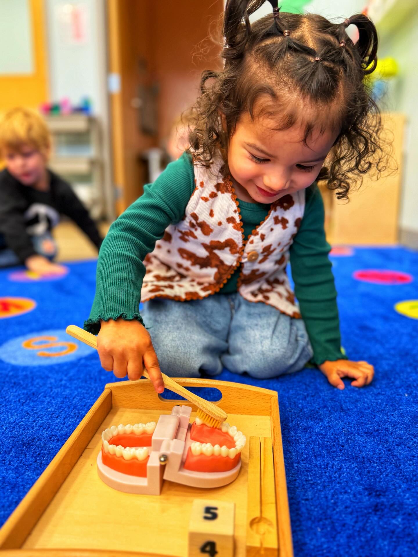 😁🦷 Today was all about El Dentista” dentists and keeping our smiles bright and healthy! 🦷✨
We started our morning talking about the important job dentists have in our community and how they help keep our mouths clean and strong. After reading a sweet story about a trip to the dentist, we learned what happens during a visit, how teeth get cleaned, and why brushing every single day matters. Of course, we couldn’t talk about teeth without singing a few fun brushing songs! 🎶🪥
Then our classroom transformed into a mini dental office. The kiddos became little dentists, carefully scrubbing “dirty” teeth with toothbrushes and water until they were sparkling clean. They were so focused on making sure every tooth was shiny! We also practiced “flossing” during sensory play, digging and pulling between pretend teeth to understand why cleaning in between is just as important.
To add some movement, we crossed a balance beam to collect letters and matched them to help “wash” the teeth, building balance and letter recognition all while staying on theme. In the afternoon, we painted bright, happy teeth and created our very own toothbrush crafts. The creativity and pride on their faces said it all.💕
It was a day full of learning, movement, imagination, and so many big smiles. We are officially becoming tooth-care experts over here! 🦷😁✨
#LittleDentists #LearningThroughPlay #PreschoolLife #CreandoMagic
