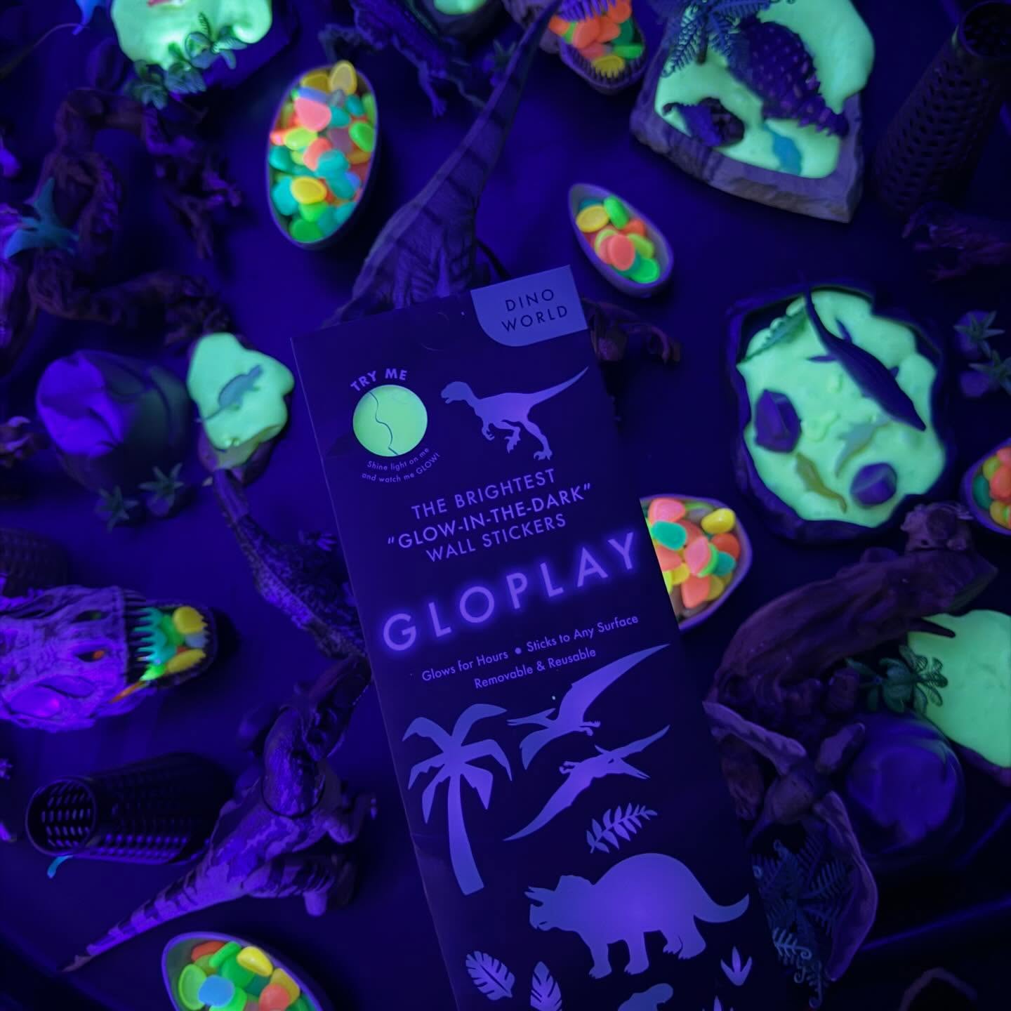 Glow-in-the-Dark Dino Small World Play// Can you think of a more thrilling duo than dinosaurs and glow-in-the-dark magic? @gloplay_usa sent us their stick-and-peel dinosaur stickers, designed to be applied, removed, & re-applied for endless adventures. Whether on walls, bathtubs, or tuff trays, these versatile stickers open up limitless opportunities for imaginative play.
For this small world play setup, a mini dinosaur landscape was recreated, with stickers thoughtfully arranged to enhance the sensory experience. “Volcano” cones, a wide assortment of dinosaur figurines, glow-in-the-dark pebbles, aquarium rocks, and homemade glow-in-the-dark slime were adde creating a truly next-level tactile adventure. To take it to the next level, black lights were used, bringing every sticker, pebble, and slime swirl to life in a mesmerizing glow.
The result? A space where children’s exploration deepened naturally. The interplay of shapes, patterns, shadows, light, and color captivated their attention, inviting longer, more meaningful play. Through carefully curated materials like these, we honor children’s interests while nurturing their imagination, encouraging problem-solving, wonder, & limitless creative thinking.
Glow-in-the-dark dinosaur adventures are more than just fun, they’re a gateway to curiosity, learning, and endless discovery. #tinkerwonderplay #tufftrayplay #tufftrayinspiration #tufftrayideas #playbasedlearning
