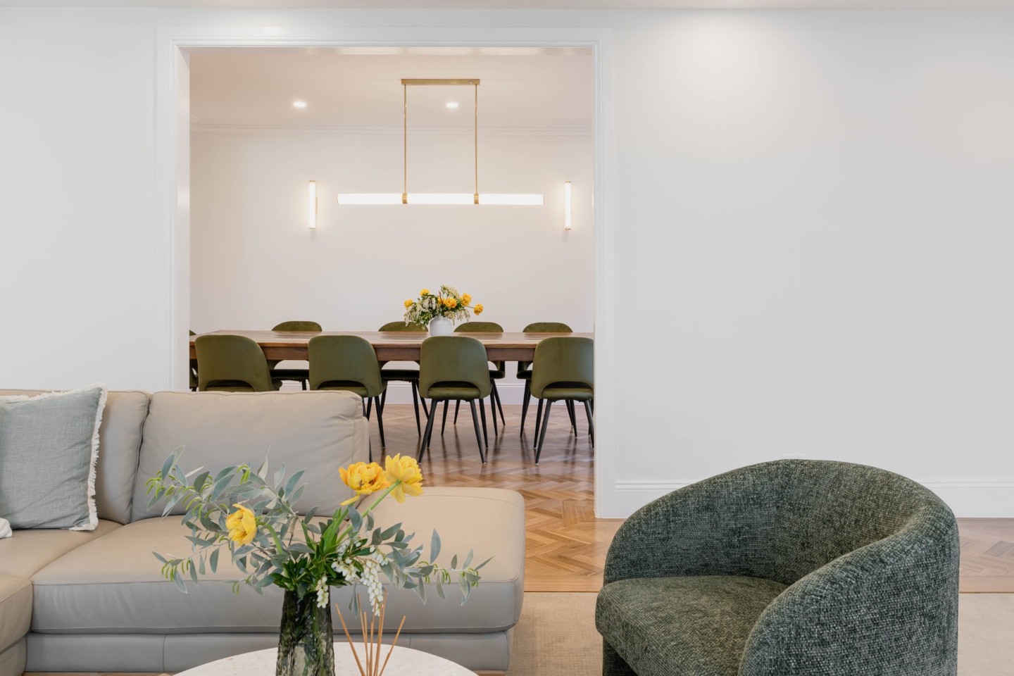 This grand home uses finishes and soft furnishings to complement the floor plan in creating cohesive transitions between spaces:
1. SOFT TRANSITIONS: Instead of transitioning from timber flooring to carpet at the threshold, the timber is wrapped around the border of the lounge room, so the carpet acts more like an oversized rug. This overlapping of the timber into the lounge room softens the transitions between spaces, and as an added bonus prevents dust build up along the edges of the room.
2. COLOUR REPETITION: Repeating the warm green colour palette as an accent in the lounge room.
📸 @benandgab
