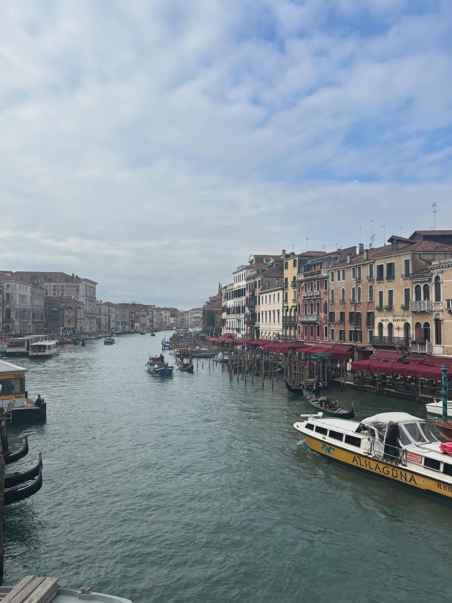 VENICE
Before I came, I did wonder… is this going to be overhyped? One of those places that looks better on Instagram than in real life.
And then I arrived.
As soon as I excited the train station the view was surreal. Mesmerising. Slightly unbelievable.
The canals hold the life of the city in their waters. They provide nourishment and are the sole means of transport for goods - they are the ecosystem that breathes life itself. Gondolas are lined up at the ready, perfectly polished and prepared to delight their impending inhabitants.
The alleyways and buildings wear their cracks like medals. No pretence, paint peeling and worn by time. There is beauty in their imperfection. Just centuries of history casually existing. Iconic.
In the end, Venice was everything I hoped for… and then quietly so much more.
Not just beautiful. Venice is layered, moody, playful and a little mysterious.
Venice didn’t just meet my expectations, she raised them, poured a glass of wine, and told me to slow down.
I left feeling like I’d only skimmed the surface. Like she showed me just enough to fall in love, but kept a few secrets tucked behind those green shutters and narrow canals.
And I already know I’ll be back.
Because Venice isn’t a one-time visit kind of place.
She’s a “come back and let me tell you another story” kind of woman, and I love that.
#venice #italy #venezia