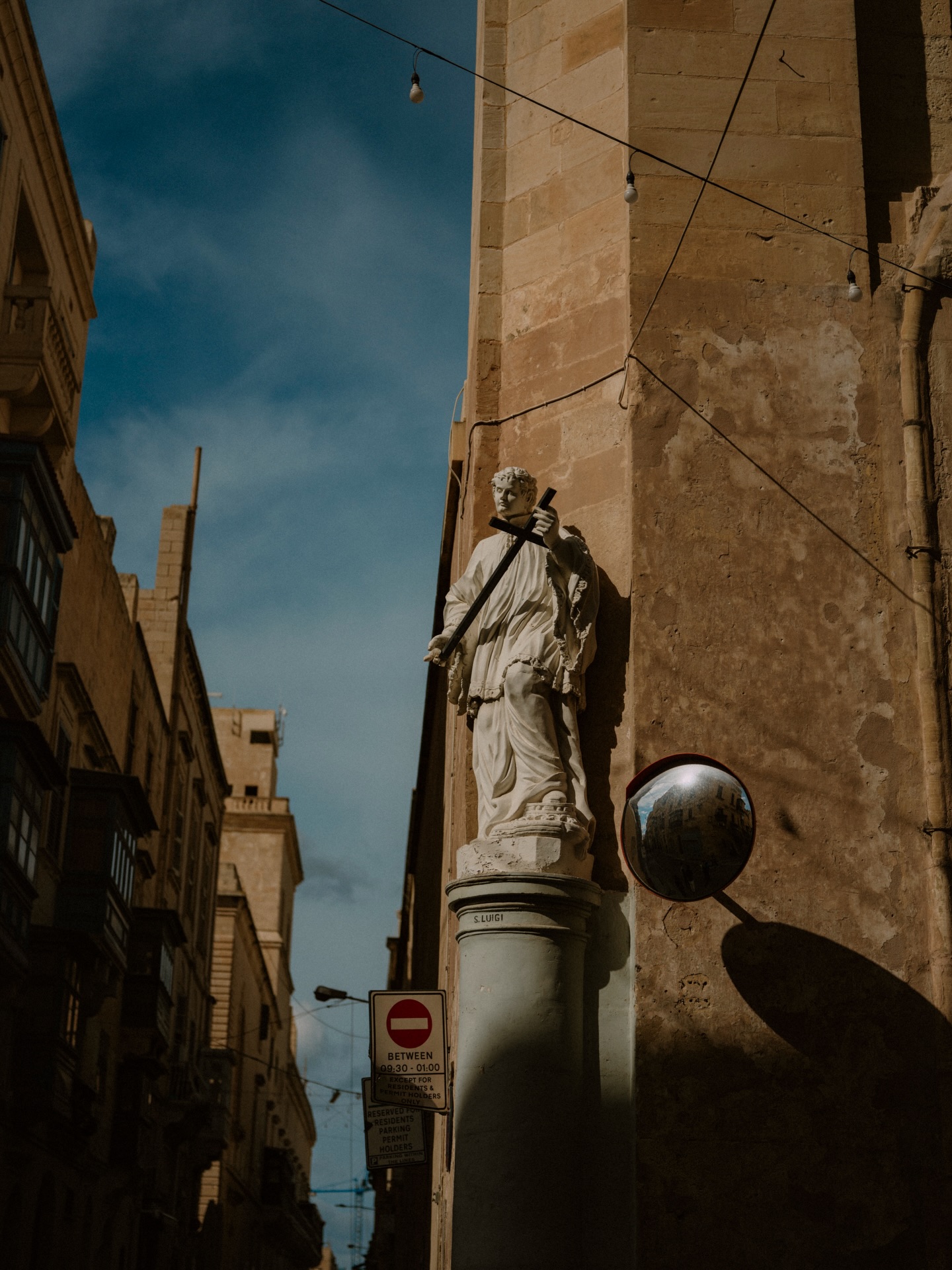 Saints rest in every corner, watching over you, or simply basking in the same sun that sanctifies your silence.