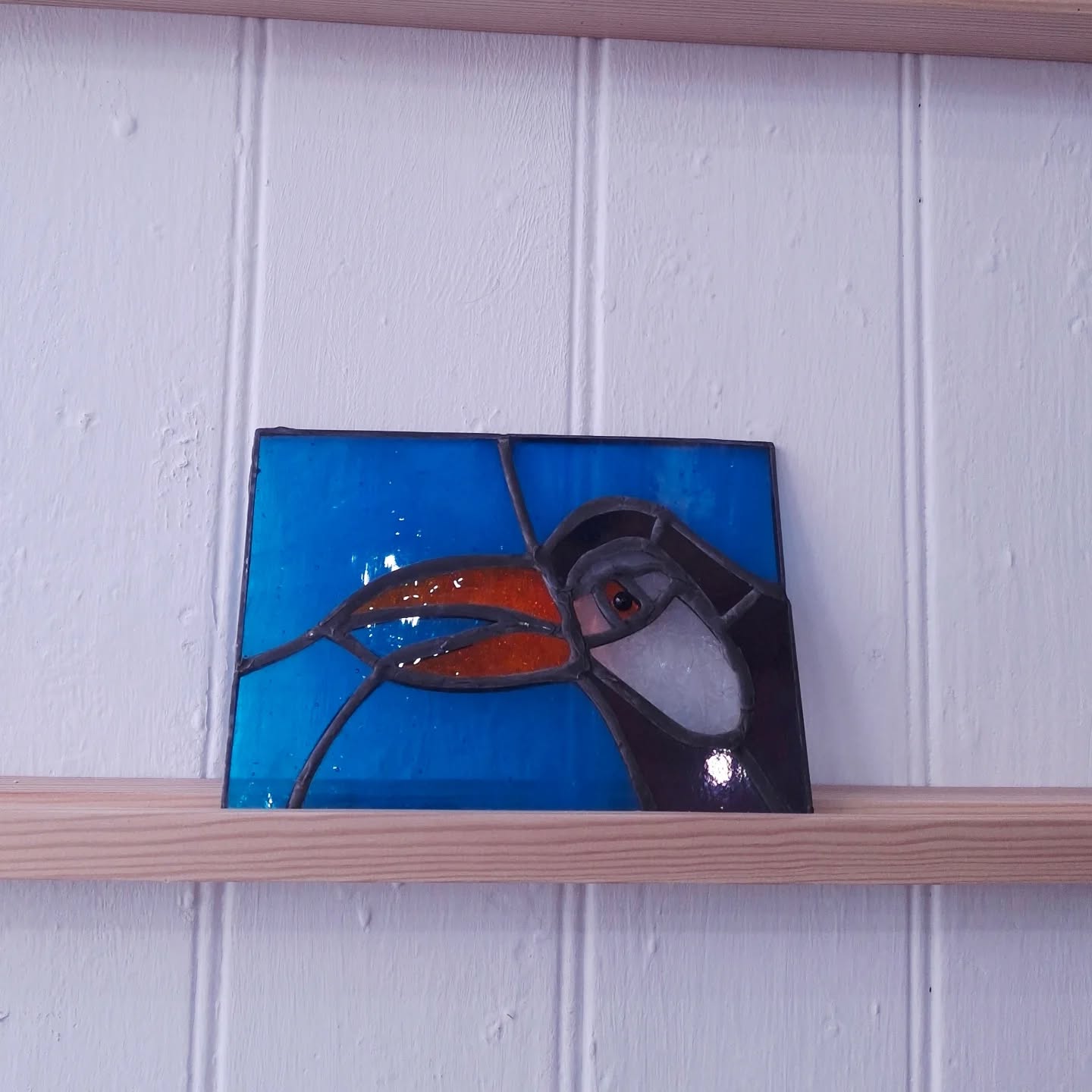 Its been lovely to take part in The Secret Postcard exhibition for the 3rd time!
I'm particularly grateful that the wonderful Becky @madeinessex agreed when I asked her if it would be okay to make my piece entirely in glass! Eeek!
Swipe for W.I.P ...particularly nice close up of me squinting at the close-up work! There have been a few questions about how its been made, here's how I did it.
1. The image - during lockdown I delved into birds and I particularly grew fond of this Toucan but ive never made such a tiny one out of glass before!
2. I drew out the cutting template- (what they call a cartoon in stained glass making)
3. I cut the glass accurately INSIDE the black line...if you cut beyond it the next stage won't fit.
4. Carefully ive wrapped 1/4 inch copperfoil around each glass fragment.
5. Each foiled fragments is tinned, a process of applying a soldering iron around all of the foil to turn it a 'tin' colour.
6. All the fragments are then soldered together, on both sides!!
Then its held to the light to see its full beauty.👏
There is still time to see my piece along with 99 other simply sublime artists Postcard creations till Saturday @70thebroadway alongside some celeb creations too! Jools Holland, Grayson Perry among much local talented. The postcards have all been sold but donations are still possible in the gallery.
All the money raised goes to support Create & Connect a critically important art dementia group @metalsouthend which couldn't continue without this support.
.
.
.
.
#stainedglass
#traditionalcraft
#madeinessex
#metalsouthend