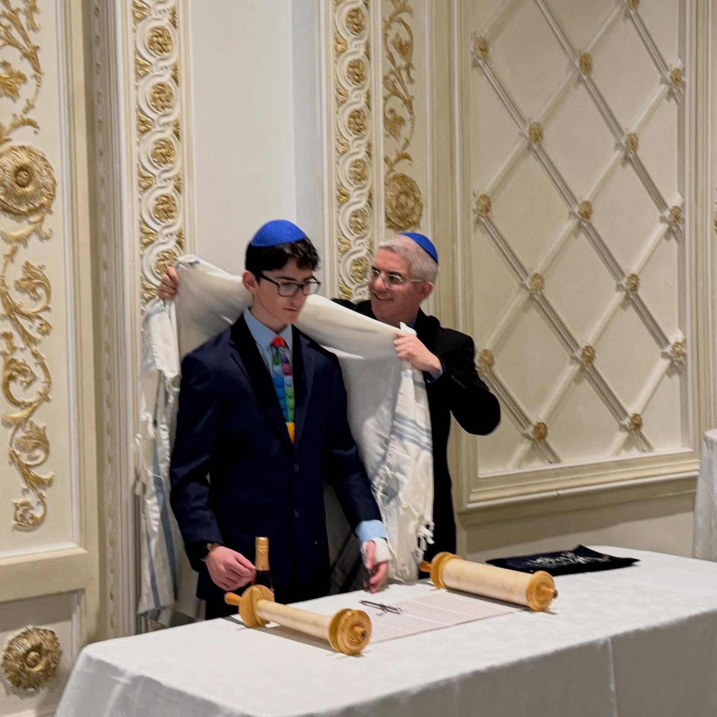 What a proud moment. A father putting on his son's Talit at his bar mitzvah ceremony. #father #son #barmitzvah #family #celebration