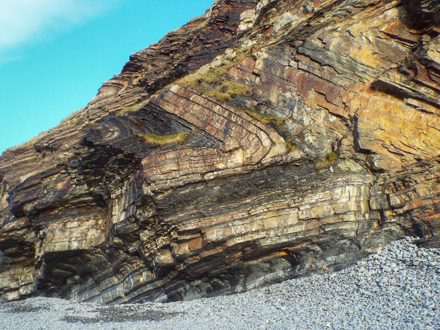 Variscan chevron folding at Millook Haven in north Cornwall.
The section visible in this photo is more than 20 m high, with a total cliff height exceeding 80 m.
These layers of sedimentary rock were originally deposited in the Culm Basin around 320 million years ago, in a shallowing ocean basin as more sediment was dumped in it as sediment gravity flows. It is stratigraphically known as the Crackington Formation.
These rocks were buried and folded as Variscan continental collision progressed northwards throughout the Carboniferous. Cornwall was effectively squeezed together like an accordion in a mountain chain for over 70 million years. This caused the inversion, or expulsion if you like, of the Culm Basin sedimentary rocks.
#millookhaven #structuralgeology #tectonics #cornwall #geology