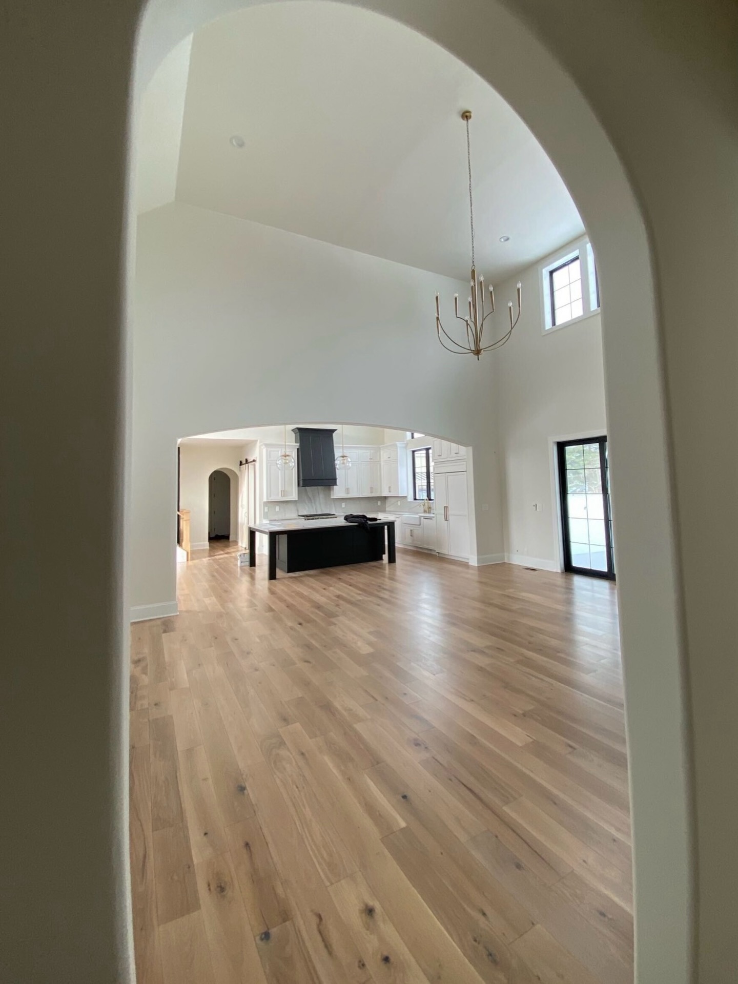 Timeless from every angle. This stunning 6” white oak, character grade, plain sawn floor in a soft Antique White finish brings warmth, texture, and quiet luxury to the heart of this home. #OldWorldCustomHomes #TimelessFlooring #GrafCustomHardwood #SimplyQuartered