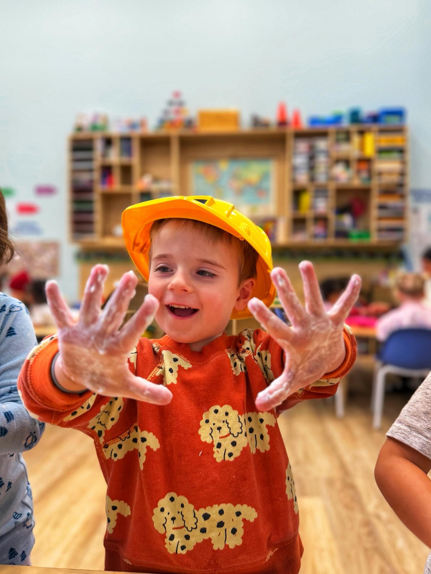 Today at Creando, our little learners explored the power of Helping Hands and how even the smallest hands can make a big difference in our community 💛
We began our day in circle time reading a story about kindness and giving, talking about how parents, teachers, and community helpers use their hands every day and how we are becoming helpers too by being kind, helping our friends, and learning to do things independently.
The children were so excited to dive into hands-on activities! 🌸 We created beautiful Helping Hands bouquets and a Helping Hands Tree, tracing each other’s hands and talking about all the wonderful ways we can use them to share, to build, to comfort, and to create. We also explored a mystery texture box using only our sense of touch, guessing what we felt before placing different textures onto our paper hands.
For fine motor practice, we traced shapes and lines using pom-poms, strengthening those little fingers while reviewing letters and shapes!
During gross motor time, we became community heroes 🚒👮♂️ The kiddos pretended to be firefighters and police officers, working together through an obstacle course to rescue stuffies from a “building.” On the rug, we hopped across “tree trunks” to build balance and coordination while cheering each other on.
We also practiced washing our hands in the sensory bin, reinforcing healthy habits while continuing our letter recognition with our helping hand creations.
It was truly a day full of teamwork, kindness, creativity, and movement. We are so proud of our little helpers and the big hearts they carry in their tiny hands 💕✨
