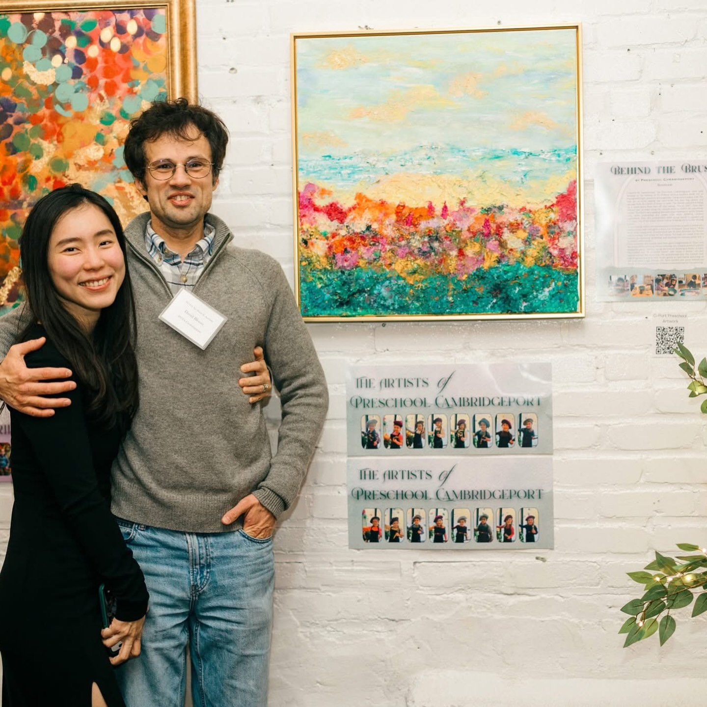 Congratulations to the Bloore Family ❤️ #POTAArtAuction
Preschool Cambridgeport: Behind the Brush
Inspired by summertime, the Preschool Cambridgeport class paid homage to the holiday of Tu B’Shvat with a creation made out of repurposed paper products and ingenuity. Using excess paper rolls, the pals got to work ripping the used-to-be tree into tiny pieces and placing them in a bowl of water to soak. The friends enjoyed holding up a small piece they tore off and saying, “It’s so tiny!” They also noticed that we were using our challah bowl to collect the minuscule scraps. This led to an engaging dramatic play experience, as the friends took turns pretending the paper rolls were different challah ingredients. Next, the preschoolers used strong hands to squeeze all the water out of the paper shreds before bringing them to the mixing station.
At the mixing station, the preschoolers stirred the soaked material into colored paint and craft glue to form our thickened “paint paste.” With every color imaginable of extra-thick goo at their disposal, the friends began making their mark on the canvas. We built our scene from the bottom up, spooning, spreading, and daubing the textured paint into a summery environment.
Once complete, the friends used their giant imaginations to “dive” into the world of the painting. Before entering, the children noticed animals within the green “bushes” along the bottom. Pointing at flecks of color, they called out, “A crocodile there!” and “Look, a ducky!” As they moved around the classroom, the preschoolers met the animals they had imagined, carrying baby ducks gently in their hands and lying on lily pads with froggy friends. We have entitled this piece Behind the Brush to honor the world the children envisioned beyond the painting.