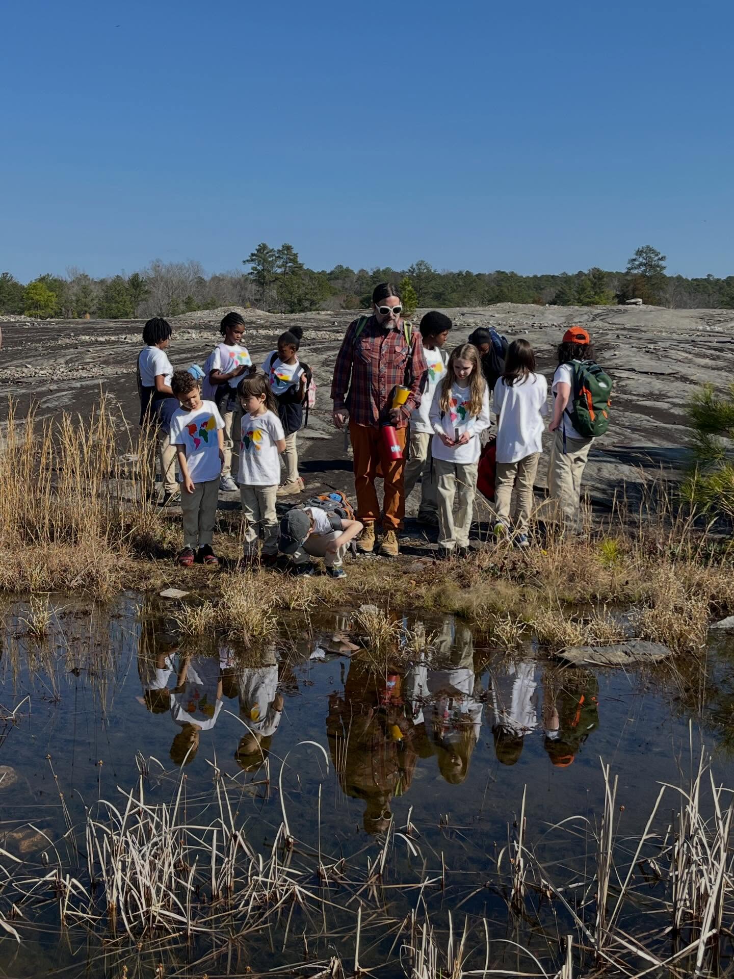 It’s a beautiful day at Arabia Mountain! The Lower School students are enjoying our mild climate and the interesting rocky outcrops teeming with life.
