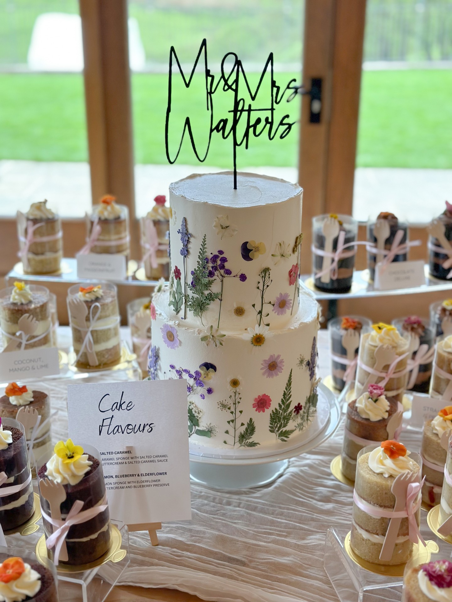 Not just a cake.
An entire dessert moment. 🌸✨
A floral pressed two tier centrepiece surrounded by individual cake jars, each tied with soft ribbon and finished with delicate buttercream swirls.
Multiple flavours. Personal portions. Beautiful presentation.
This style is perfect for couples who want variety without compromising on elegance. Guests can choose their flavour, admire the details up close, and enjoy something that feels thoughtfully curated rather than standard.
The centre cake anchors the design. The individual jars create interaction. Together, they turn dessert into part of the celebration.
If you are planning a wedding and want more than a traditional slice and serve, let’s design something immersive.
View the portfolio:
https://www.kimberlyjaynecakedesign.co.uk/portfolio
Enquire via the website to check availability 🤍
#LuxuryWeddingCake #WeddingDessertTable #PressedFlowerCake #ModernWeddingIdeas #ElegantWeddingDesign