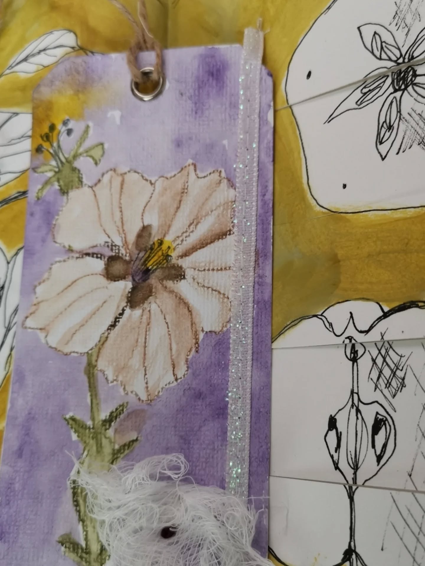 I loved this lesson because it was quick, rewarding, no fuss, and relaxing almost meditative. Green gold acrylic mixed with transparent yellow iron oxide, plus titan green pale. I almost always pre-gesso my pages but I loved how the paper soaked up the paint and made it a silky-like texture. The tag has some glitter ribbon, with cheesecloth and a burgundy french knot. The flower on the tag was painted in watercolor.
@raemissigman #wanderlust26class #eaclasses