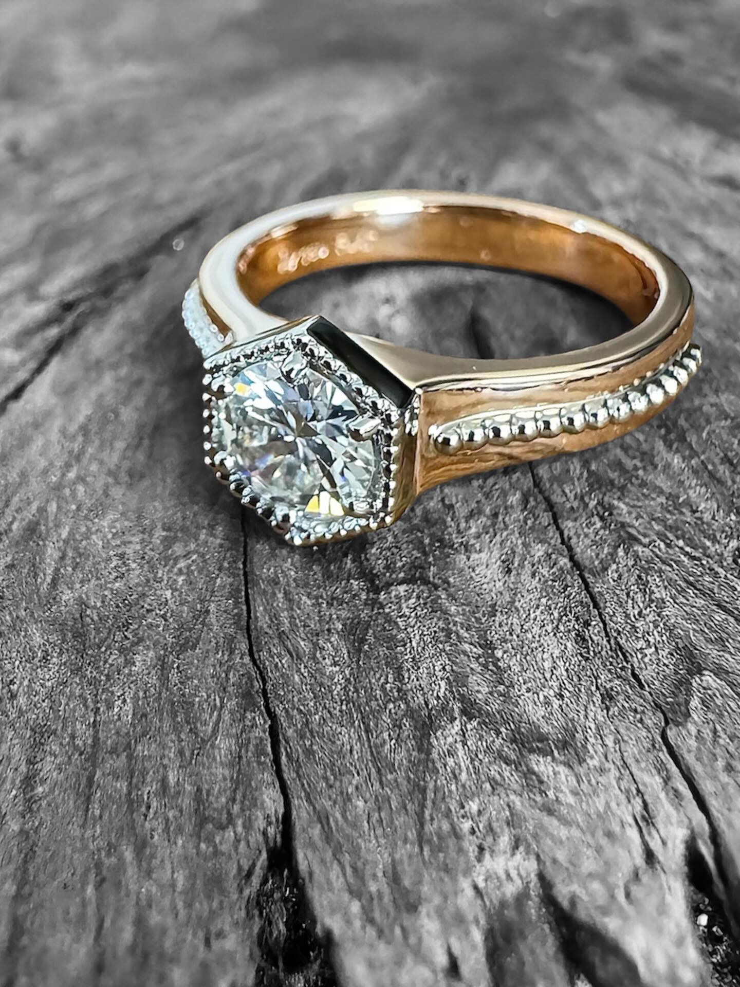 One of my favourite types of remakes to do, creating one new statement piece from an original wedding set. It makes sense to me, our styles and tastes change over time. When it's time for a major repair or remake, what an opportunity to create something new that reflects who you are now.
The original diamond still has pride of place, with hidden birthstones set inside the band to represent family. Platinum and rose gold take over from the traditional yellow gold set. The beaded detail down the centre of the band conceptualises the multiple ring wedding set, without the discomfort of 2 or 3 rings spinning around and ruining the symmetry of your masterpiece ๐