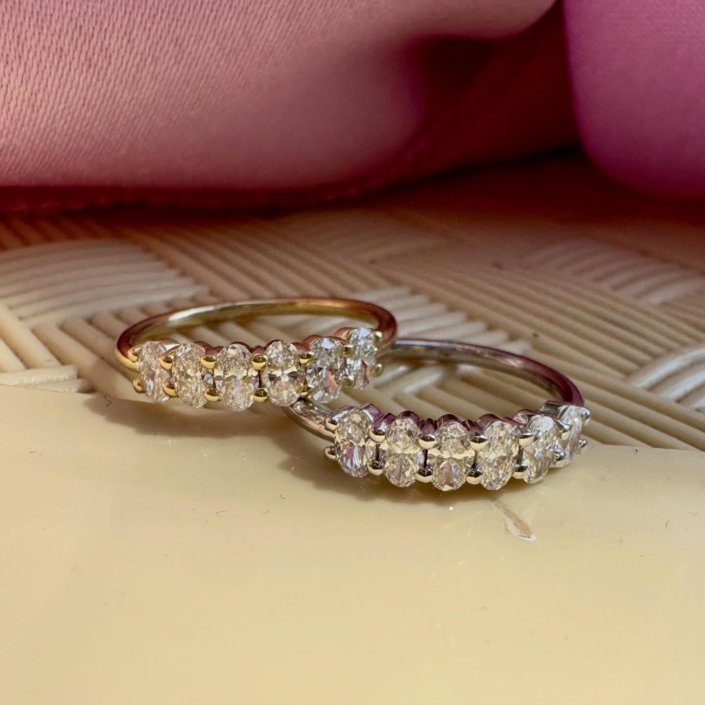 An elegant half-eternity ring featuring oval-cut d…