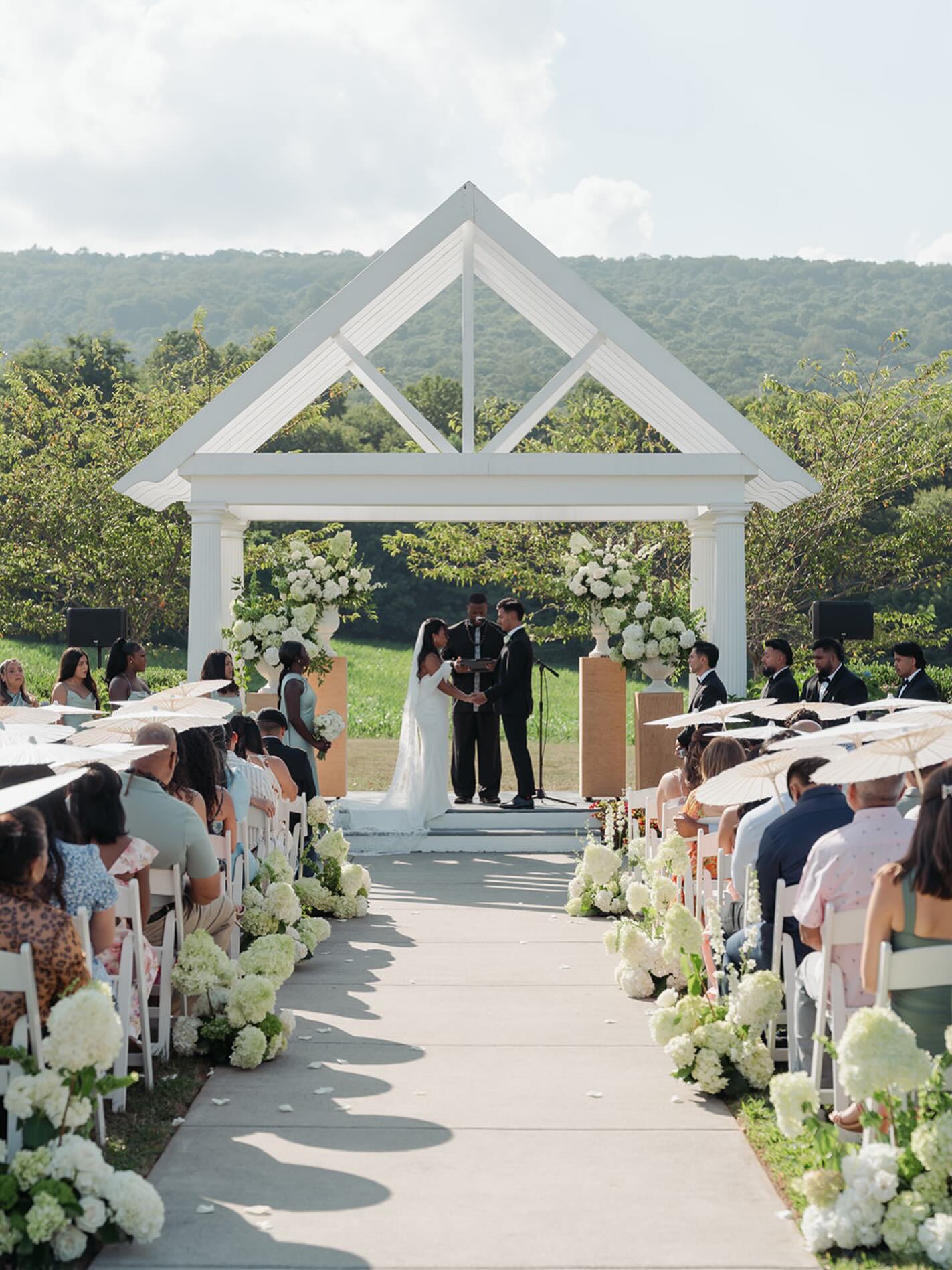 Absolutely obsessed with the florals from this day. Mixed with the parasols for guests during this hot day. It made for such a beautiful ceremony event. Love love love everything about this absolutely beautiful day!
Coordination - @dmvweddingsandevents
Venue - @springfield_manor
Photo - @isabelbrachophotos
Florals - @thurmanandfig
Hair - @beyond.the.updo
Make up - @beautifulliflawedbridal
Mocktail supplies - @gatewayliquors
Rentals - @countrycreekfarmhousetables
Photo booth - @activephotobooth