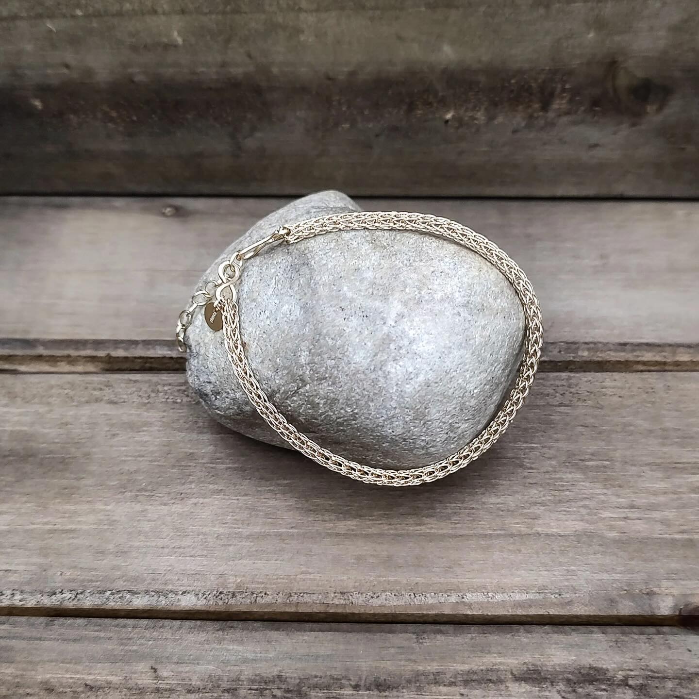 Viking Knit gold bracelet by @rigrcrafts. ✨Beautiful! Earrings and necklaces available as well.
•••••
Description
These bracelets are made with 14 karat gold-filled wire and come with additional chain for adjustable length. See the available size options in the dropdown! Complete the set by adding a matching necklace and earrings available in our Viking Knit Jewelry section.
Viking knit, also known as Trichinopoly Chain, was most popular during the late 9th and early 10th centuries (which is why it is known as Viking knit) and was worn by both men and women. All of our Viking knit jewelry is made in a historically accurate way by taking long pieces of wire and “knitting” them round a dowel to form a tube, then pulling the tube through a draw plate to the desired diameter. Each bracelet uses approximately 15-20’ of wire and each necklace uses 30-45+’ of wire. See the last photo for an example of REAL in work Viking Knit from Viking Age Scandinavia in my personal collection for educating about historical jewelry at events! We also can make these pieces in raw copper, oxidized copper, brass, bronze, or sterling silver.
What is gold-filled metal? Gold-filled metal is made by heat and pressure-bonding a thin layer of karat gold to a brass core. Gold-filled metals are 5% gold (compared to .05% gold in plated pieces) which makes them hypoallergenic, durable, and the gold won’t rub off or tarnish with proper care!!! The best part is it’s much more affordable than solid gold.
See the available options for the current length and diameter of chains in stock and ready to ship. Additional jump rings for adjustable length can be added on request.
If the length/diameter you would like is not currently in stock, please message us for custom order info.