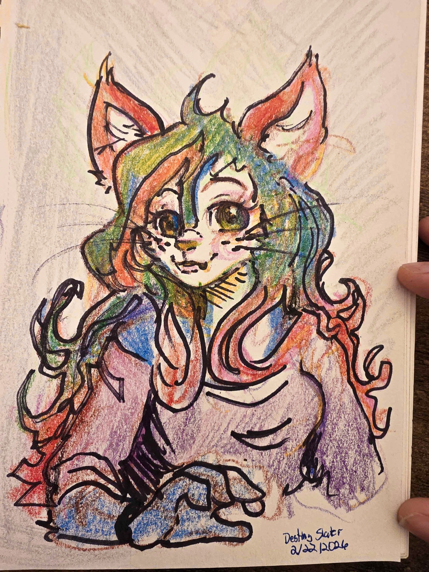 I randomly decided to play with @crayola twisty crayons and used a @sharpie permanent black marker as an outline. I drew my long-time original character, DestinyMew. Enjoy!
--
Image description 1:
A picture of a traditional drawing of a female anthro cat from the bust up. Her arm is idling in front of her. The colors are apparently to be fought with various coloring techniques, but overall it is mainly a blue cat with pink secondary fur color and a purple shirt. In the bottom-right corner, it is signed by Destiny Slater on 2/22/2026.
Image description 2:
A selfie of Destiny with her hair pulled back, her front blonde bangs slightly blocking her right eye. She is smiling and holding up a Crayola Fun Effects Twistables Crayons box.