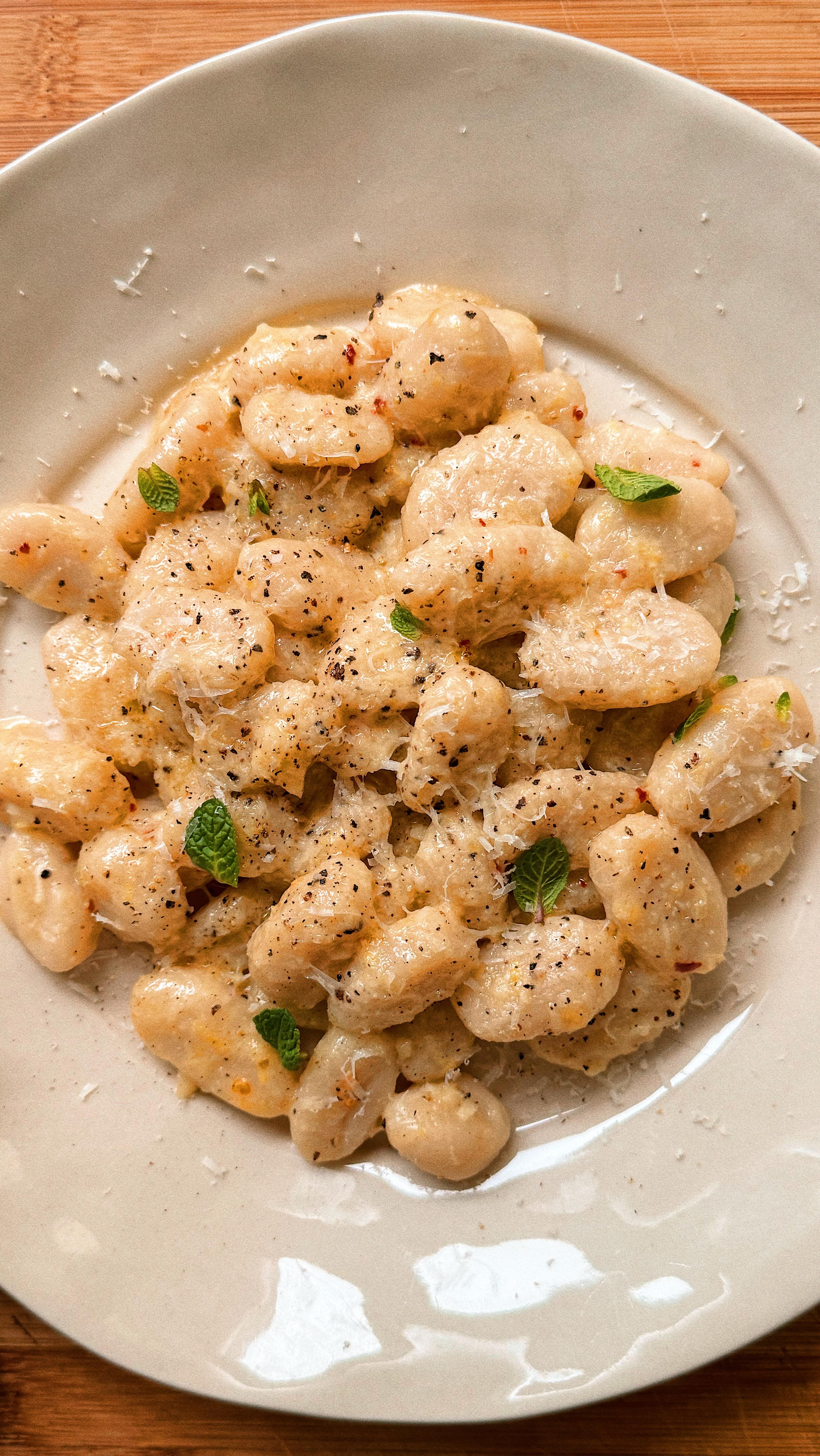 When you’re craving comfort but want to stick to your health goals, @sunnyandlunaeats gnocchi is the perfect thing! I’ve paired the cauliflower gnocchi with a lovely, buttery lemon sauce for the ultimate Sunday dinner!
Serves 2
You’ll need:
30g salted butter
1 lemon, zest and juice
1 garlic clove, finely chopped
½ tsp chilli flakes
250g @sunnyandlunaeats cauliflower gnocchi
30g Pecorino, plus extra to serve
Sea salt and freshly ground black pepper
Fresh mint or basil leaves, to serve
Melt the butter in a large frying pan over a medium heat, and add the lemon zest, garlic, chilli and plenty of black pepper. Cook for a couple of minutes, then turn off the heat.
Bring a large pan of salted water to the boil and cook the gnocchi until they float. Drain, reserving a mugful of pasta water.
Add the gnocchi, Pecorino, lemon juice and a little pasta water to the butter pan and put on a low heat. Cook, stirring regularly, and keep adding pasta water until a smooth sauce is formed.
Divide between two bowls and top with the mint leaves and a little more Pecorino.