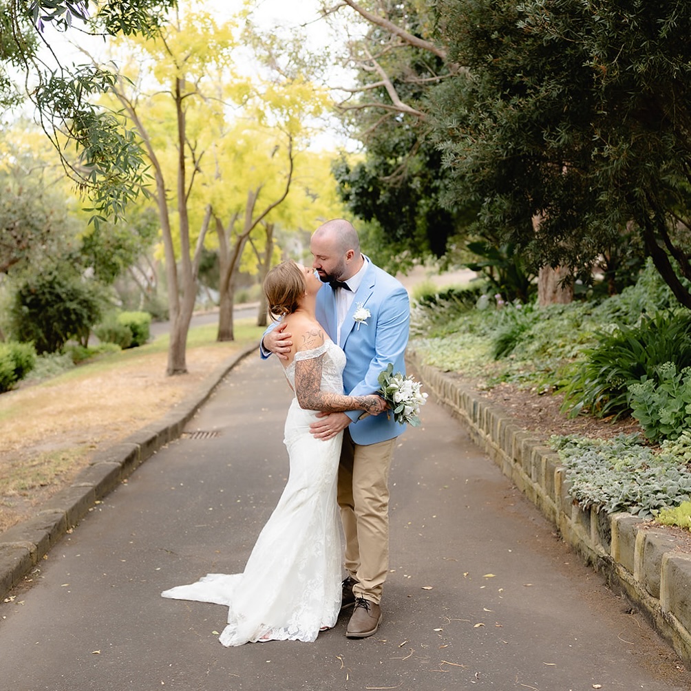 Jade and Adrian’s wedding day was simple, steady and centred on each other.
After their ceremony, they stepped away for a quiet walk beneath the trees, taking a moment to pause and let it all sink in.
No fuss. No audience. Just the two of them, holding each other close and beginning this next chapter with calm confidence.
Intimate, grounded and unmistakably theirs.