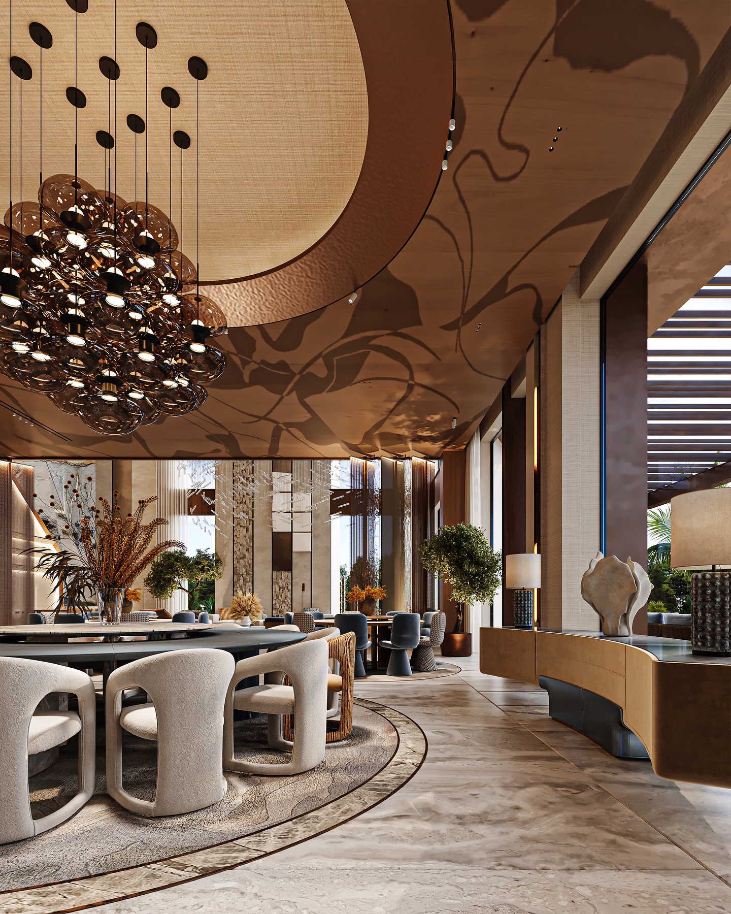 A dining space shaped by light, material, and rhythm.
At the center of the room, a sculptural chandelier becomes the visual anchor, suspended beneath a custom-designed ceiling that transforms lighting into an ever-changing pattern across the space.
Circular seating arrangements organize the room with clarity and balance, creating intimate zones within an open layout. Natural stone flooring, warm wood tones, and soft neutral upholstery establish a calm and refined atmosphere.
Large openings bring daylight deep into the interior, allowing the architecture, materials, and shadows to evolve throughout the day.
A space designed not only for dining, but for experience.
Riyadh, Saudi Arabia
Design by Maroon Architects
