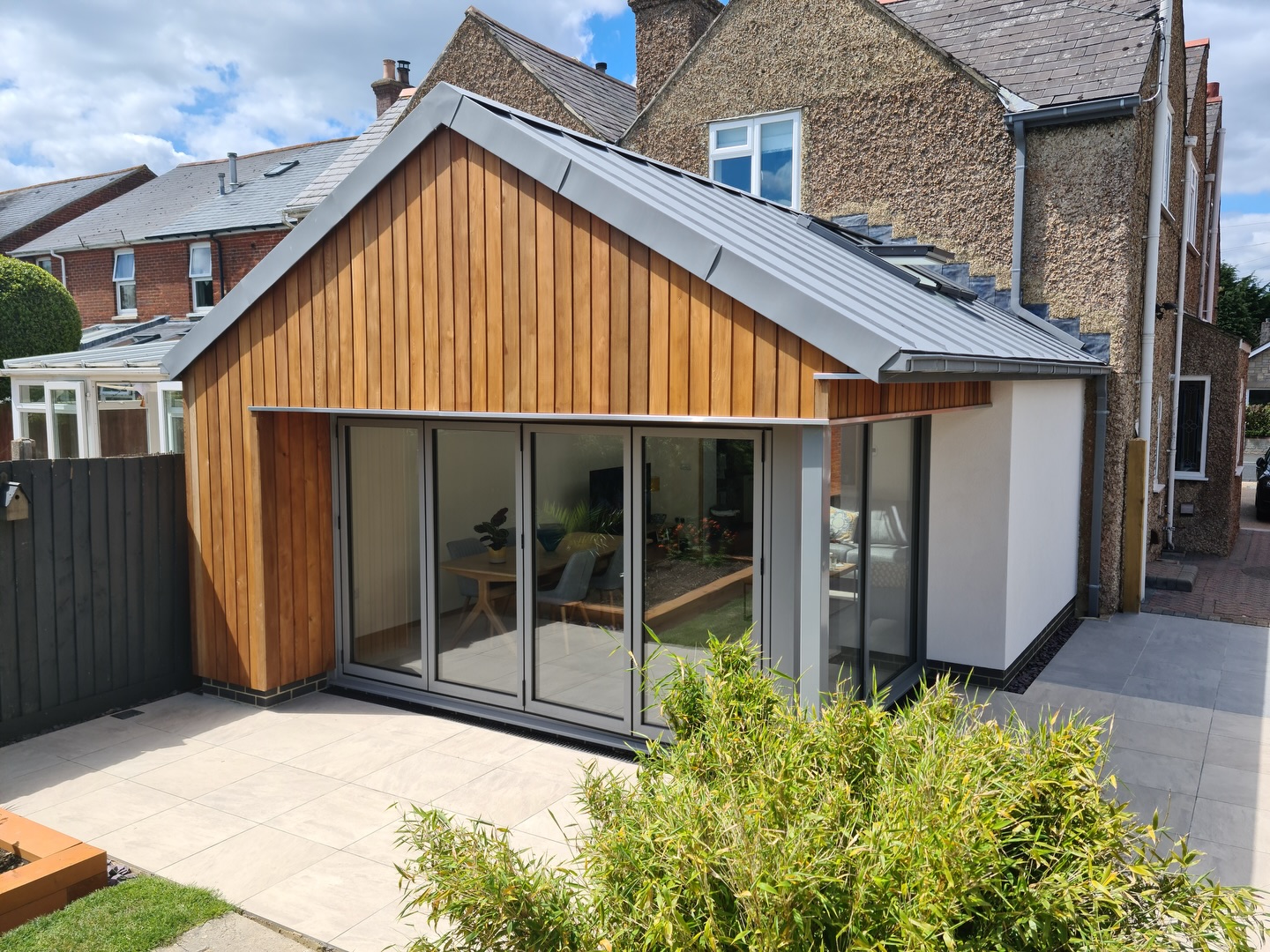 From conservatory to contemporary! Swipe to see the before ๐
An old conservatory replaced with a sleek modern extension, cladded in vertical timber, with corner glazing and bi-folding doors to open the house to the garden.