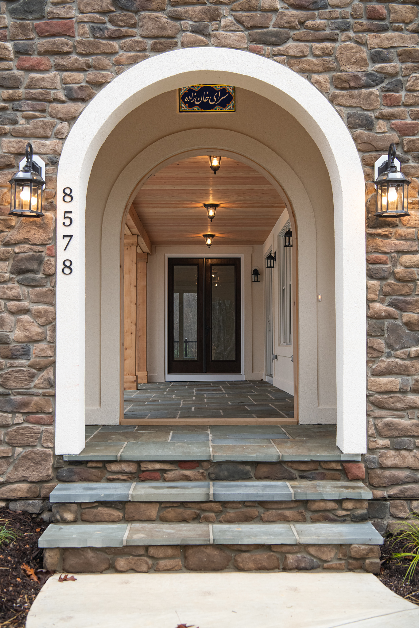 This entryway keeps the home’s original charm. Stone, arches, and all, while introducing thoughtful updates that feel timeless.