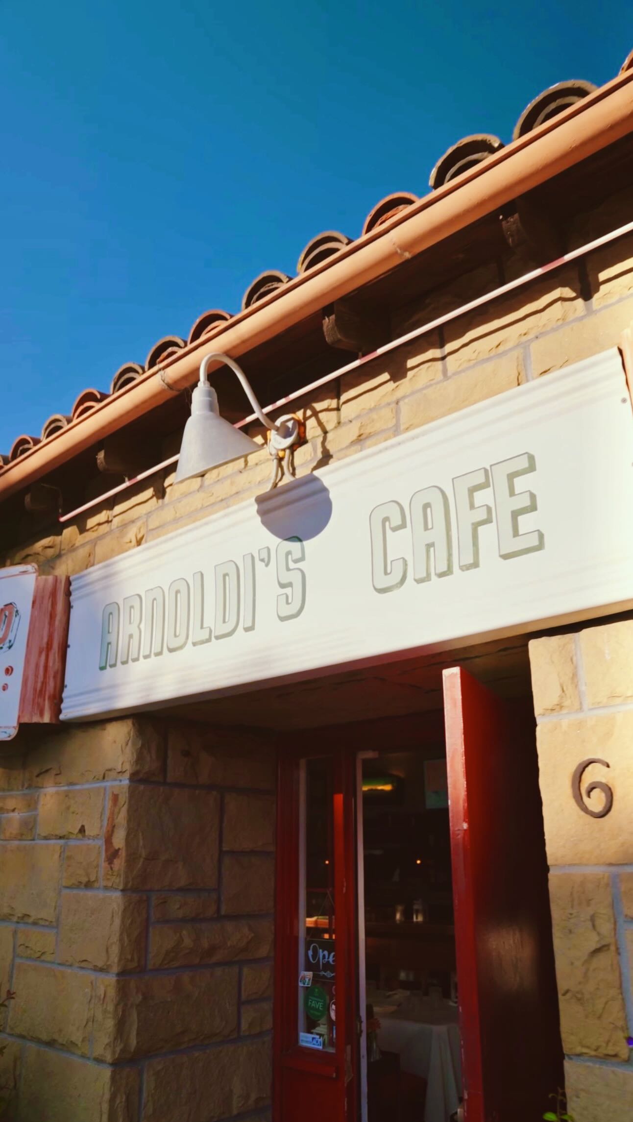 “Joe Arnoldi’s Cafe”, as it was formerly named, was built by the hands of Joe/Giuseppe himself.
A skilled sandstone mason, he was a businessman at heart, first opening a stone masonry business then a pub that sold food made by his wife Ilda. Some of Joe’s handiwork you may be familiar with. Reportedly, he worked on the rebuilding of the Mission, the courthouse, and much of the stonework downtown following the 1925 earthquake.
Giuseppe arrived to Santa Barbara from an area near Lake Como in northern Italy in the early 1920s and settled in around lower Eastside, which at the time had a large Italian immigrant community near Cota and Olive Streets. By 1937, he and Ilda had opened their first cafe location at 421 East Cota Street. In 1940, they decided it was time for a permanent home. And so, Joe and his workers hand-quarried local sandstone to build the restaurant we know today at 600 Olive Street, and they completed it in just 3 months.
After a long day of work laying stone, the Italian workmen needed a place to eat a big, calorie-dense dinner. And so, Joe provided. They commonly ate pasta, bread, sausages, and hearty stews, smoked cigars, drank wine, and played bocce on the back patio. From the 30s through the 50s, Women were generally not allowed in the back patio, but children were allowed to fetch their fathers.
The “Little Italy” of sorts has since dispersed but the “I Madonna Festival” remains, a direct nod to these roots.
Guest foodie appearance by @andieatssb!
Thank you to @musicmels22 for the idea, suggesting this video!
🎥: @sineadsantich
Sources:
Arnoldis.com/about
LA times
Noozhawk
The Independent
Through the Eyes of Italy, Erin Graffy
SB Historical Museum
The Restaurant Guy (John Dickson)