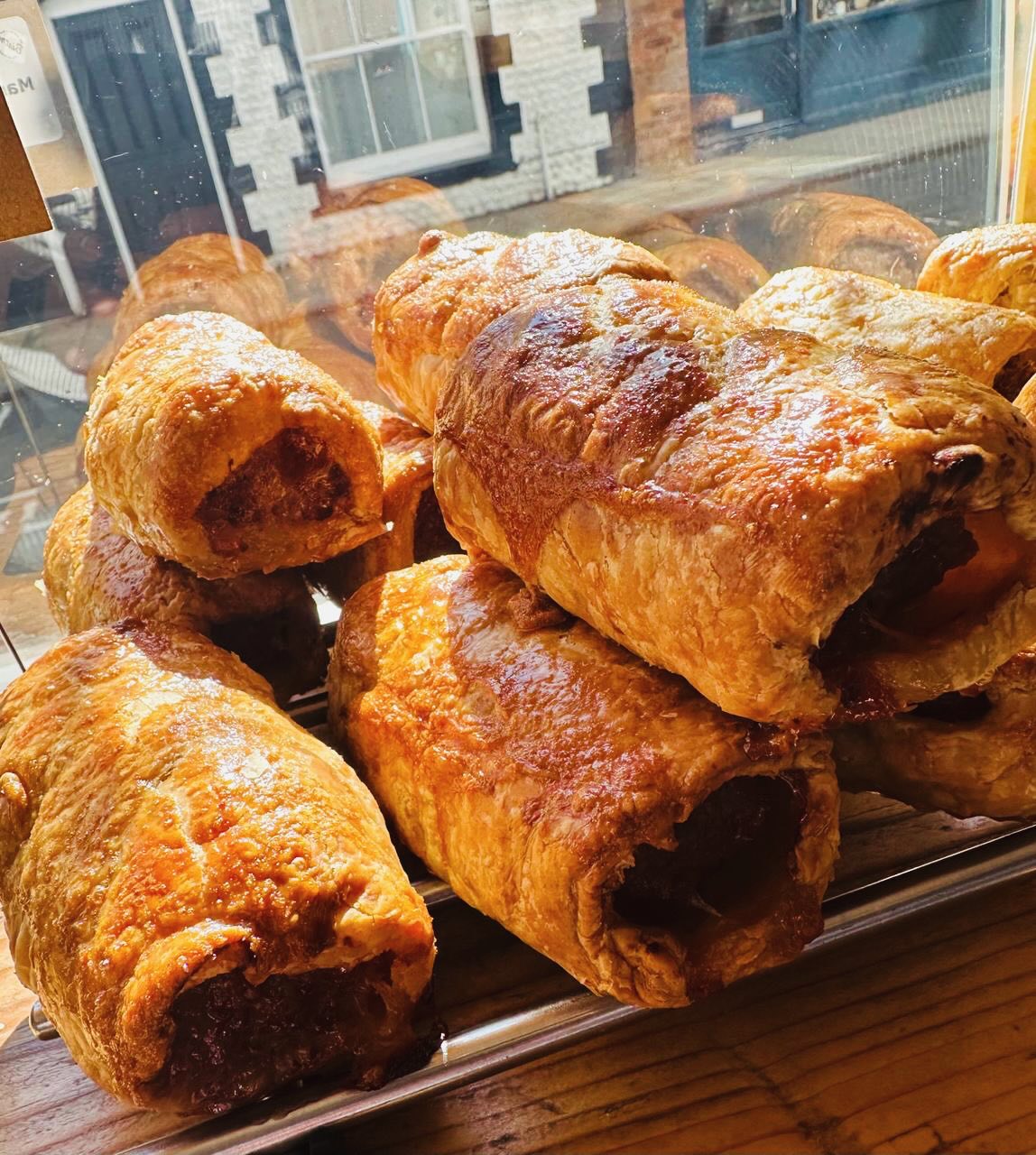 👨🍳 Homemade Bistro Favourites
Kicking things off with our No.1 best seller: The Signature Norfolk Sausage Roll!
If you’ve caught one fresh from the oven, you’ll know exactly what we mean.
Starting around 20 years ago with a single sheet of puff pastry and around a kilo of Norfolk sausage meat from Cromer butcher, Icarus Hines (now The Butcher’s Joint), the team now hand-roll several hundred a week. Not only our No.1 seller at both The Bistro and West Street Deli, but our most popular wholesale product, and always the first thing people check will be included in outside catering buffets.
The introduction of our Christmas Cranberry & Stuffing Sausage Roll has led to a variety of flavours, changing roughly every six weeks throughout the year including crowd pleasers such as Marmite or Cheddar & Leek to the more adventurous Chipotle & Jalapeno or seasonal Haggis Rolls.
Plant-based Sweet Potato & Chickpea Rolls were started around 8 years ago, intended as a special but as an immediate hit has stayed on as a permanent favourite and strong wholesale option.
Which option is your No1? Flavour ideas we haven’t tried yet? Let us know in the comments!
For wholesale enquiries, DM us or email: sam@theoldrockshopbistro.co.uk