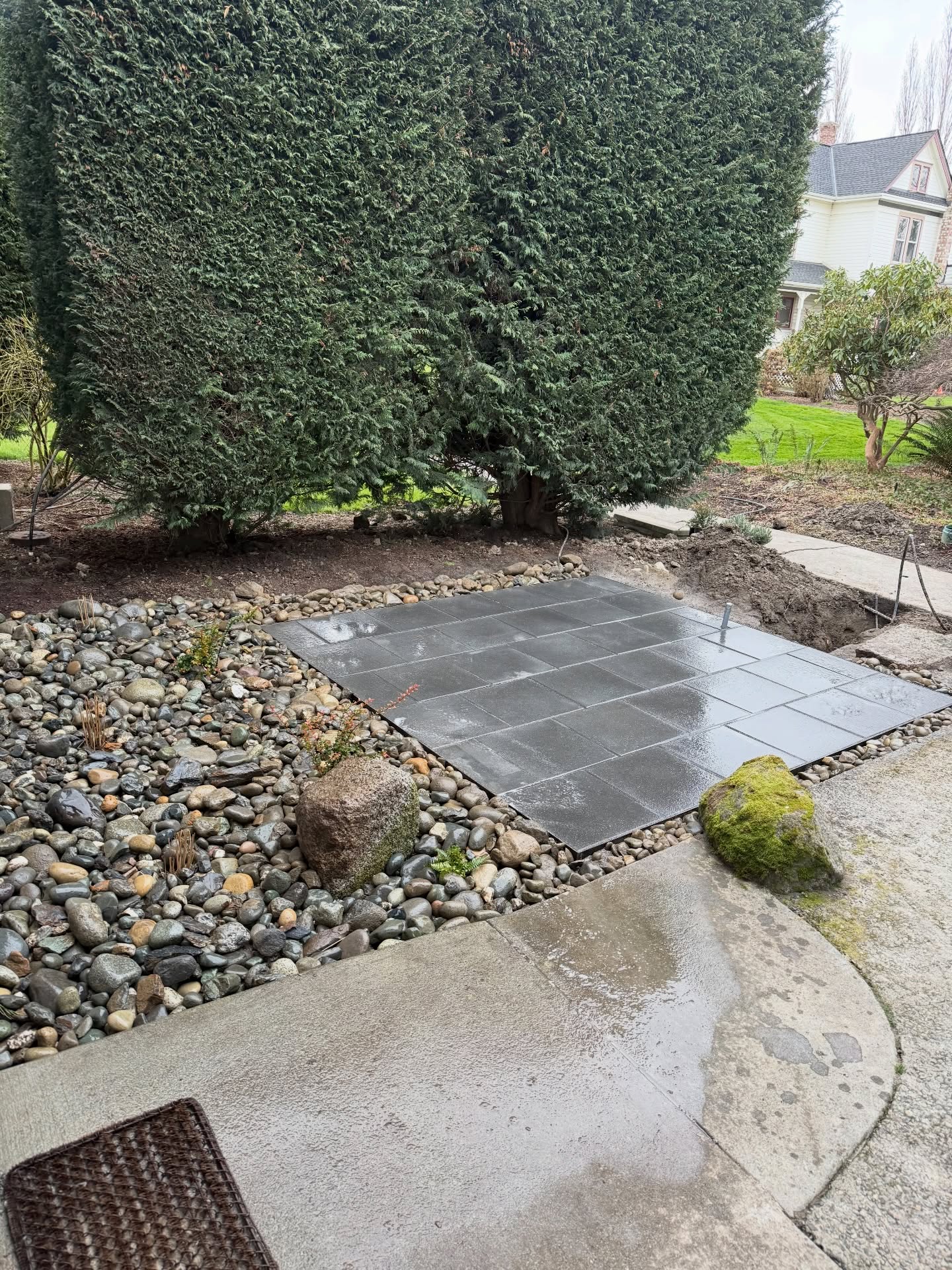 Polymeric sand installed in the paver joints today for a clean, durable finish. We also placed a yard of cobble around a few evergreen huckleberries, miscanthus grasses, and a sword fern — anchored with a boulder we found right on site.
Once the electrical is finalized and the hot tub is set, we’ll return to complete the pathway leading up to the steps.
Had my little man on site helping today — best kind of workday. 💚