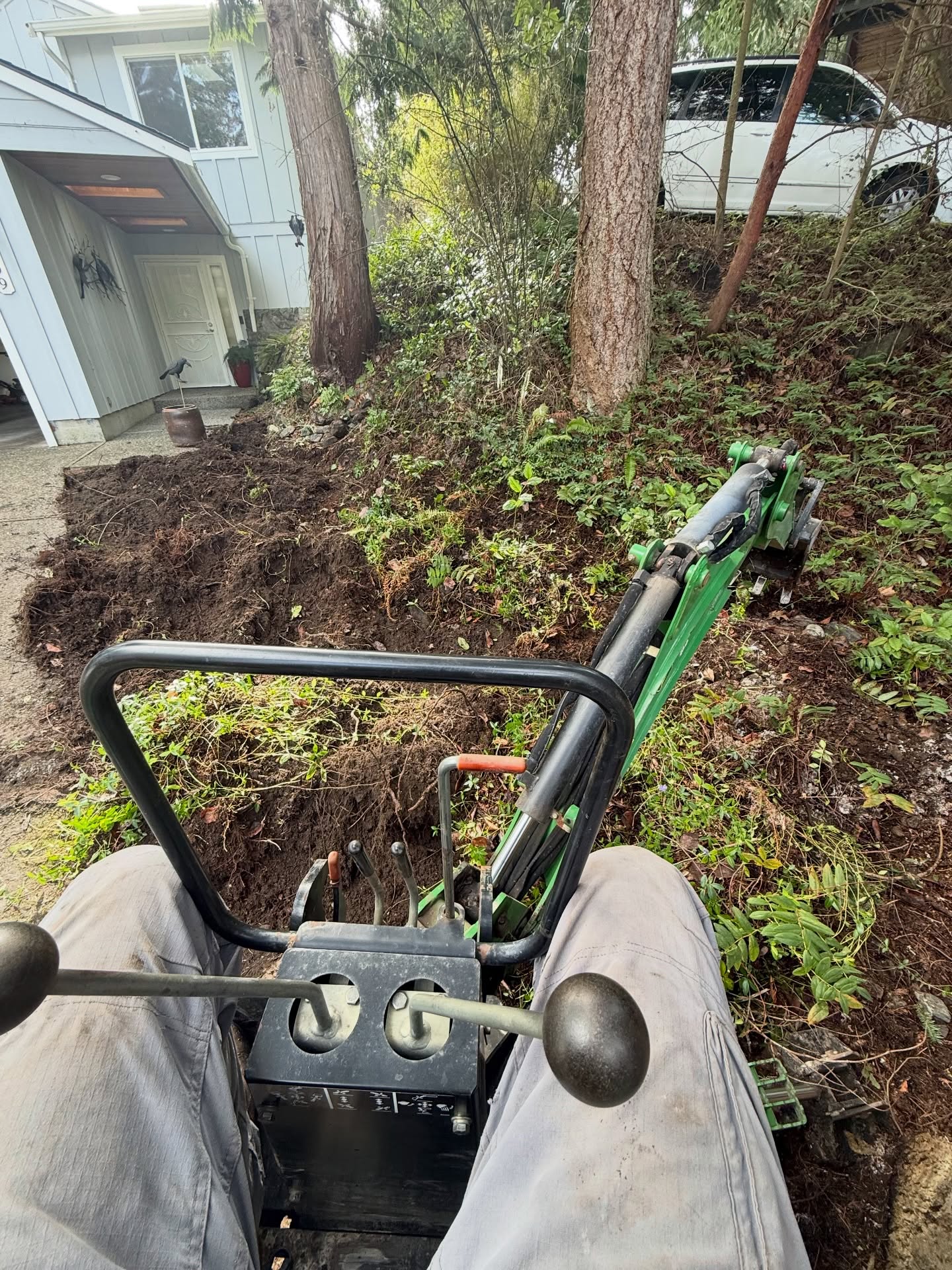 Sometimes the old John Deere is the best tool for the job.
We’re removing a thick infestation of Vinca minor from this woodland landscape and digging deep to get as much of the root system out as possible. Left unchecked, it can quickly take over the garden.
This area is getting a fresh start. Next up we’ll be bringing in native plants and a few well-placed boulders to rebuild the understory and restore a more natural feel to the woods.
— Tobias
Grass Roots Lawn & Garden 🌿