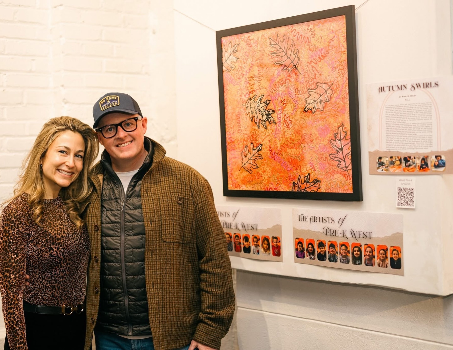 Congratulations to the Yoffe-Hanley Family ❤️ #POTAArtAuction
West Pre-K: Autumn Swirls
Our art piece, Autumn Swirls, was inspired by the fall season and our observations and comparisons between fall and the winter season we are currently in. As we explored our surroundings, we noticed the many ways nature—flowers, trees, and leaves—changes across the two seasons. We observed that fall creates a warm atmosphere, highlighted by rich colors such as orange, yellow, red, brown, and hints of pink. These observations inspired both the color palette and overall design of our artwork. We also discussed activities we enjoy during the fall, and one favorite was watching leaves fall from the trees, swirl in the autumn breeze, and drift to the ground for us to stomp and play in. This joyful experience inspired the name of our piece, Autumn Swirls.
We began our artwork using a familiar art medium that we had previously explored while creating our Thanksgiving cards. We combined shaving cream with red and yellow watercolor paint, swirling the colors together to create unique designs and mix new shades, like orange. We then scraped the shaving cream mixture onto our canvas to form the base of our artwork. Next, we painted leaves black and pressed them onto the canvas, creating imprints that served as templates for further design.
The final step was the most exciting, a brand-new art medium for our class: paint piping. To learn this new skill, we practiced using paint in plastic piping bags, focusing on making wavy lines and swirls. Using the piping bags made us feel like bakers, so we also experimented by piping designs onto pretend cakes and clay gingerbread men. This process encouraged mindfulness and careful control in our art. When it was time to add these lines and swirls to our final piece, we felt like experts as we carefully piped designs inspired by leaves drifting and swirling in the autumn breeze.