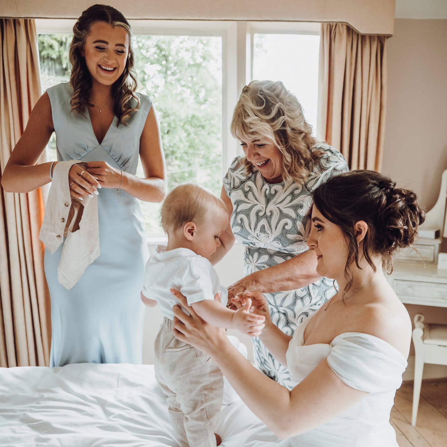 Three generations.
One quiet moment. 🤍
While the world waits downstairs, this is where the real magic happens. A mum fastening tiny buttons. A sister adjusting a bow. A little one being dressed for a day she might not fully understand yet — but will one day look back on in photographs and feel.
Weddings aren’t just about the aisle or the dance floor. They’re about the legacy in the room. The hands that raised you. The sister who’s been there through every chapter. The child watching it all unfold, soaking in what love looks like.
These are the moments that become family history.
The ones that feel small now… but mean everything later.
#EssexWeddingPhotographer
#EssexWeddings
#BridalPrepMoments
#DocumentaryWeddingPhotography
#NaturalWeddingPhotography