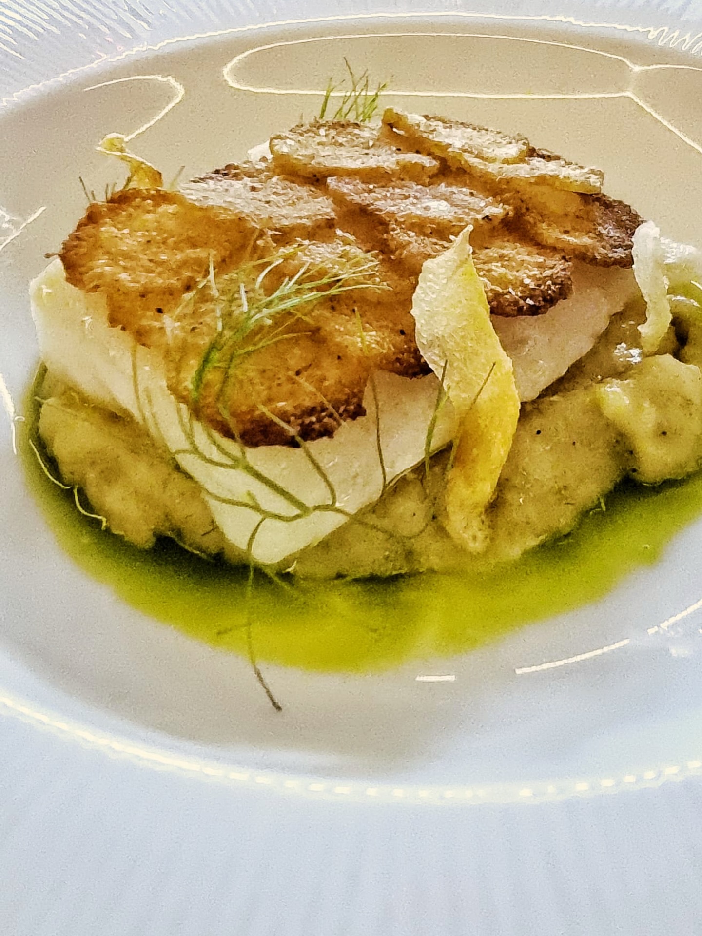 And then there was fish. But not just any fish: one of the treasures of local freshwaters… the marble goby, or soon hock.
Delicately confit and then finished with savoury spiced potato scales in the oven, the flakey fillet sits on a fennel purée studded with vesicles of lemon and crisped ginger, with a drizzle of mint oil.